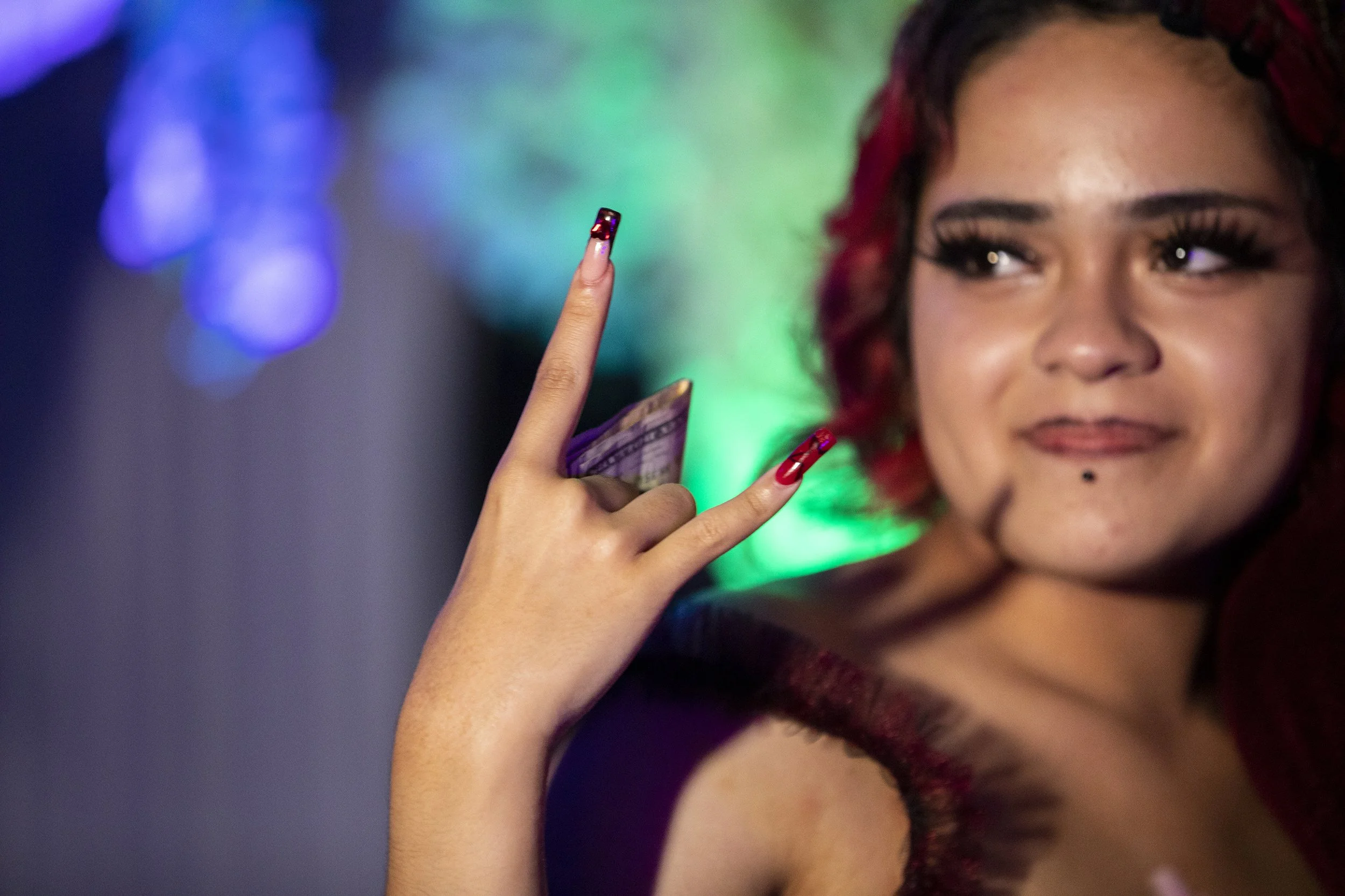  Annalya Torres holds cash that she received. 