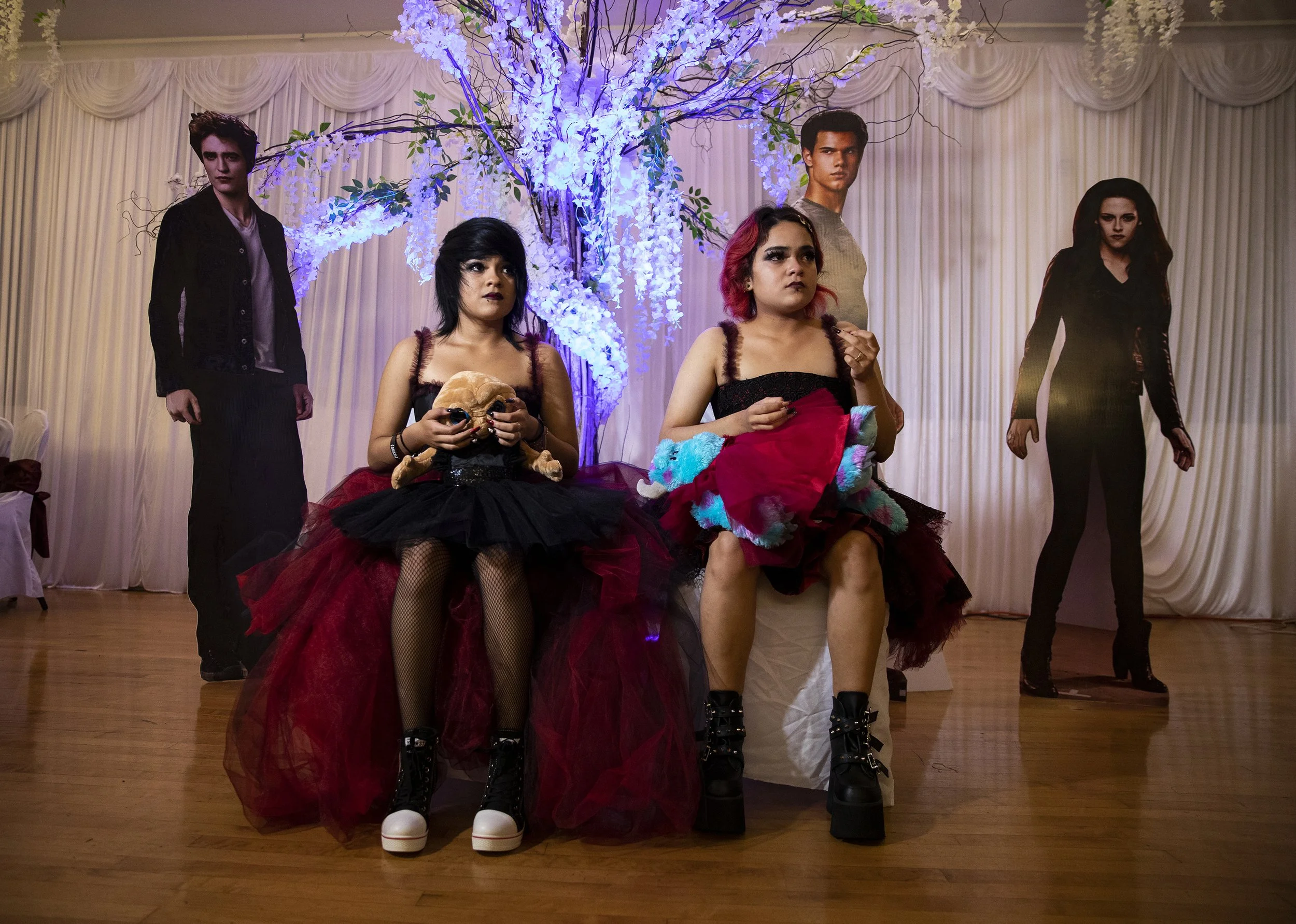  Twins Alinna, left, and Annalya Torres, right, pose for photos during their Twilight themed quinceañera. 