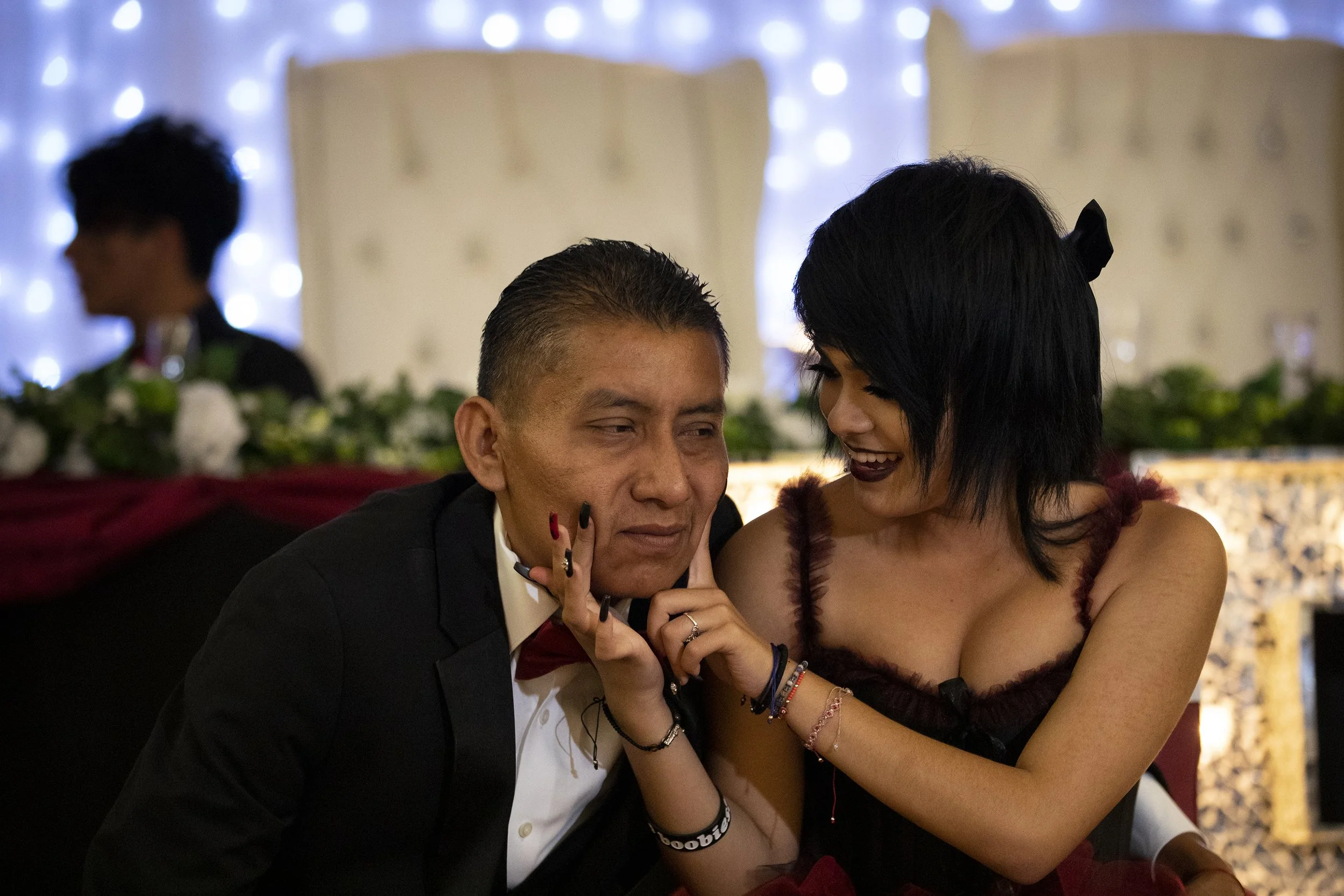  Alinna Torres, 15, teases her father, Beto, to smile during her quinceañera. 