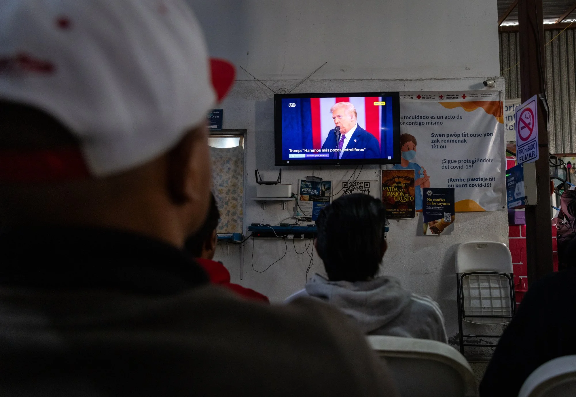 Migrants staying at a shelter watch President Donald Trump's inaugural speech on television on Monday, Jan. 20, 2025 in Tijuana, Mexico. 