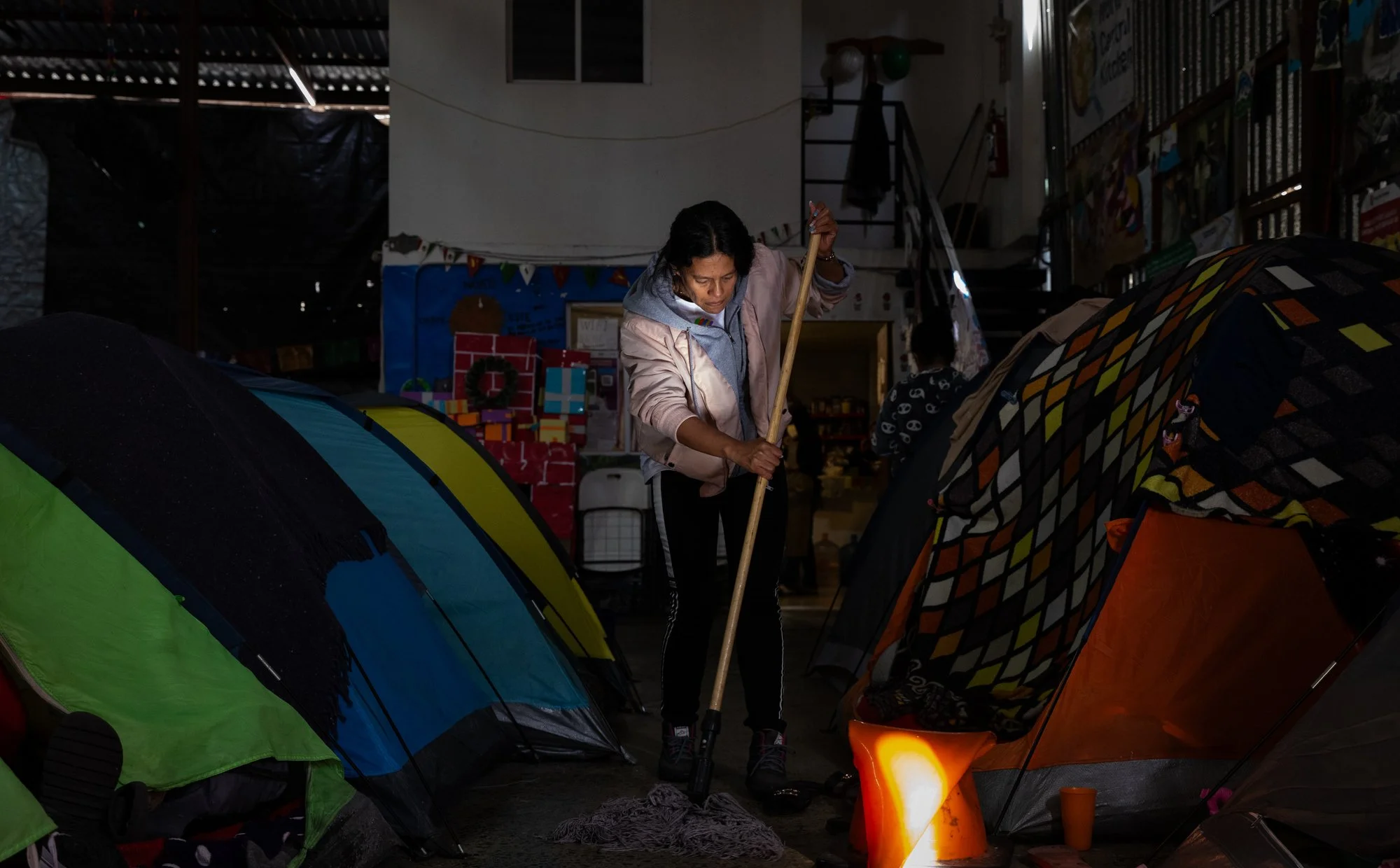 Milagro Gonzalez cleans after finding out that her CBP One appointment was cancelled.