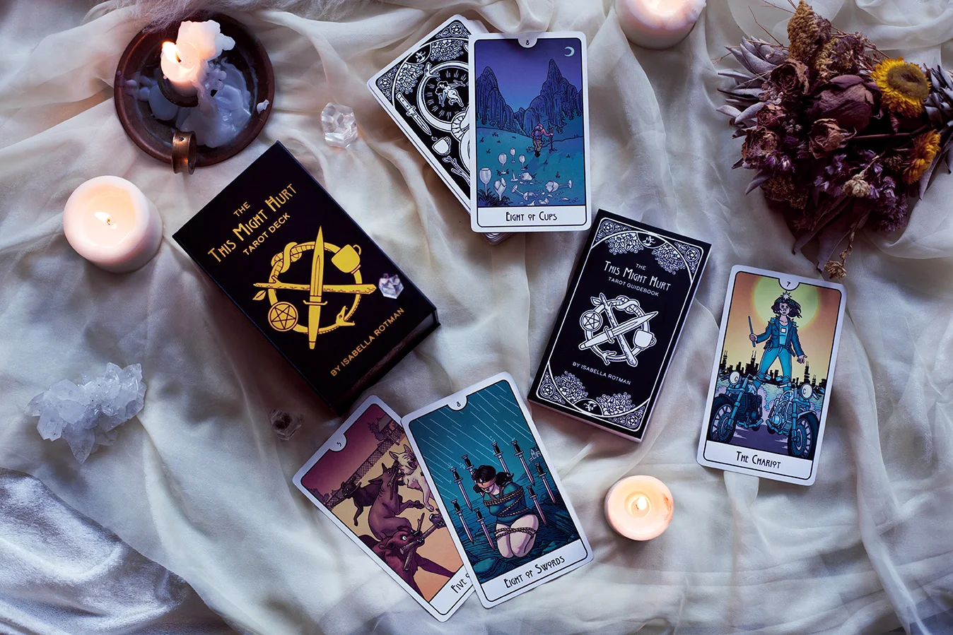Image show This Might Hurt Tarot deck box, guidebook, and several cards laid out.