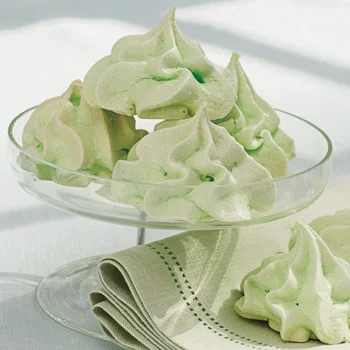 makes 24 cookies prep time 15 minutes baking time 3 hours cooling time 20 minutes 3 egg whites, at room temperature 1/4 teaspoon cream of tartar, McCormick® 3/4 cup granulated sugar 1⁄2 teaspoon mint extract or white crème de menthe 2 to 3 drops green food coloring Special Equipment Pastry bag #4 star tip 1. Preheat oven to 200 degrees F. Line 2 heavy large cookie sheets with parchment paper. 2. Beat egg whites in clean large metal bowl on medium speed until foamy. Add cream of tartar. Increase speed to high and continue beating until soft peaks form. Gradually add sugar, 1 tablespoon at a time, beating until stiff peaks form, about 5 minutes. Quickly mix in mint extract. Stir in food coloring, 1 drop at a time, until desired color is achieved. 3. Spoon meringue into pastry bag fitted with star tip. Pipe twelve 1 1/2-inch-high ×1 1/2-inch-diameter mounds onto each prepared cookie sheet, spacing evenly apart. Bake for 3 hours or until dry and crisp. Cool meringues completely on baking sheets. Store in airtight container at room temperature.