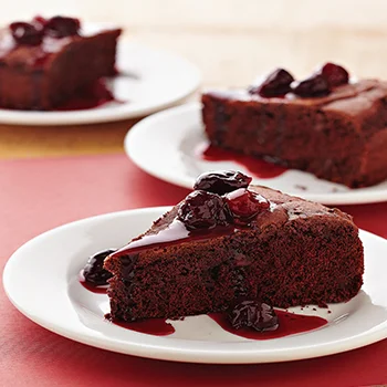 Makes 8 servings Cooking spray 1 pouch (17.5 ounces) double chocolate chunk cookie mix 1 cup Bisquick baking mix 1⁄4 cup unsweetened cocoa powder 1 cup chocolate milk 2 tablespoons vegetable oil 1 cup frozen cherries 1⁄2 cup cherry preserves 2 tablespoons light corn syrup 1. Preheat oven to 350°F. Coat a 9-inch round cake pan with cooking spray. 2. In a large bowl, combine cookie mix, baking mix, and cocoa powder. Add chocolate milk and oil and beat with an electric mixer on medium for 2 minutes. Pour into cake pan. 3. Bake for 35 to 40 minutes, or until a wooden pick inserted near center comes out clean. Cool in pan on a wire rack for 10 minutes, then turn out onto rack to cool completely. 4. In a medium microwave-safe bowl, combine frozen cherries, preserves, and corn syrup. Microwave on medium (50%) about 4 minutes, or until preserves are melted and mixture is heated through. 5. Cut cake into wedges. Top each serving with some of the cherry mixture