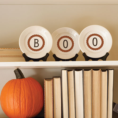 Dress up everyday dishware with scrapbook stickers from a craft’s store and prop on easels to display throughout the Halloween season.