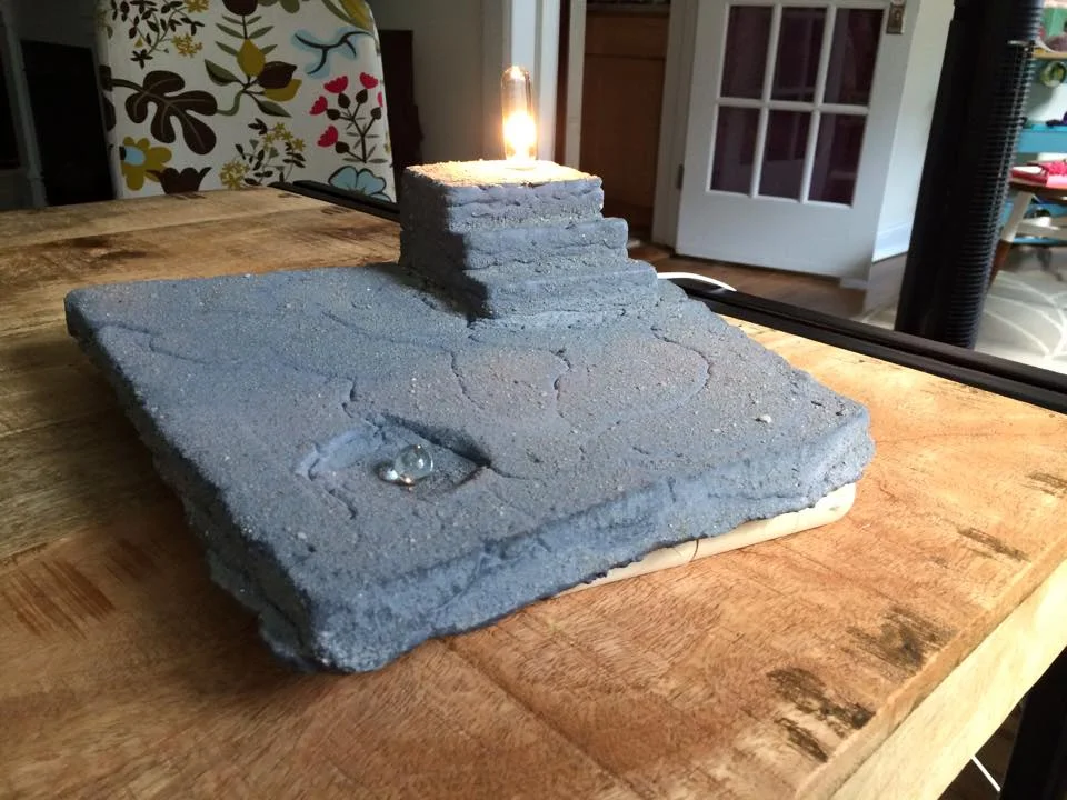 Elevation, 2015. Sand-cast cement, light kit. Private collection.