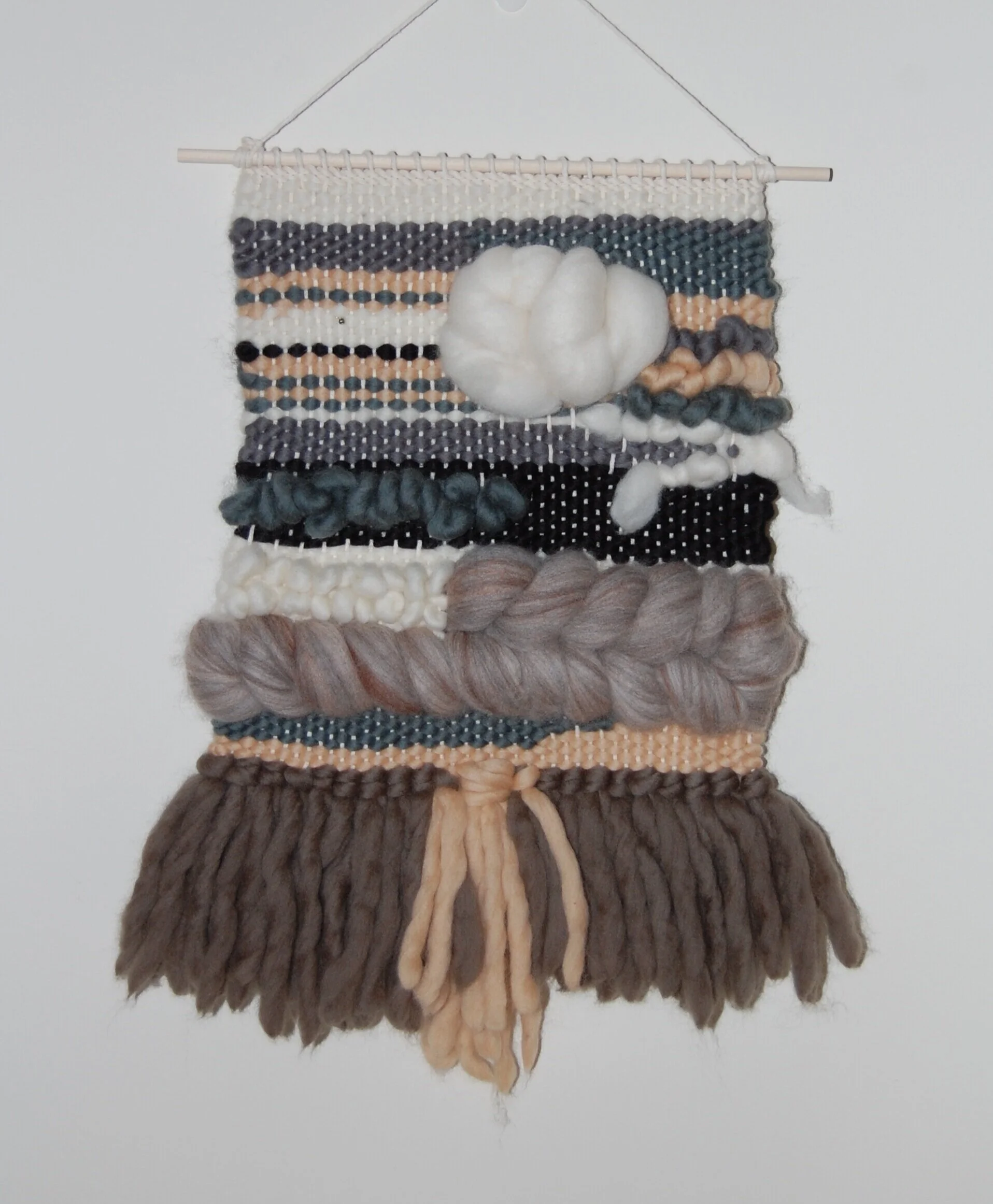 Savannah, 2019. Woven wool yarn and micron roving over cotton warp with wooden dowel and mini pyrite charm. Private collection.