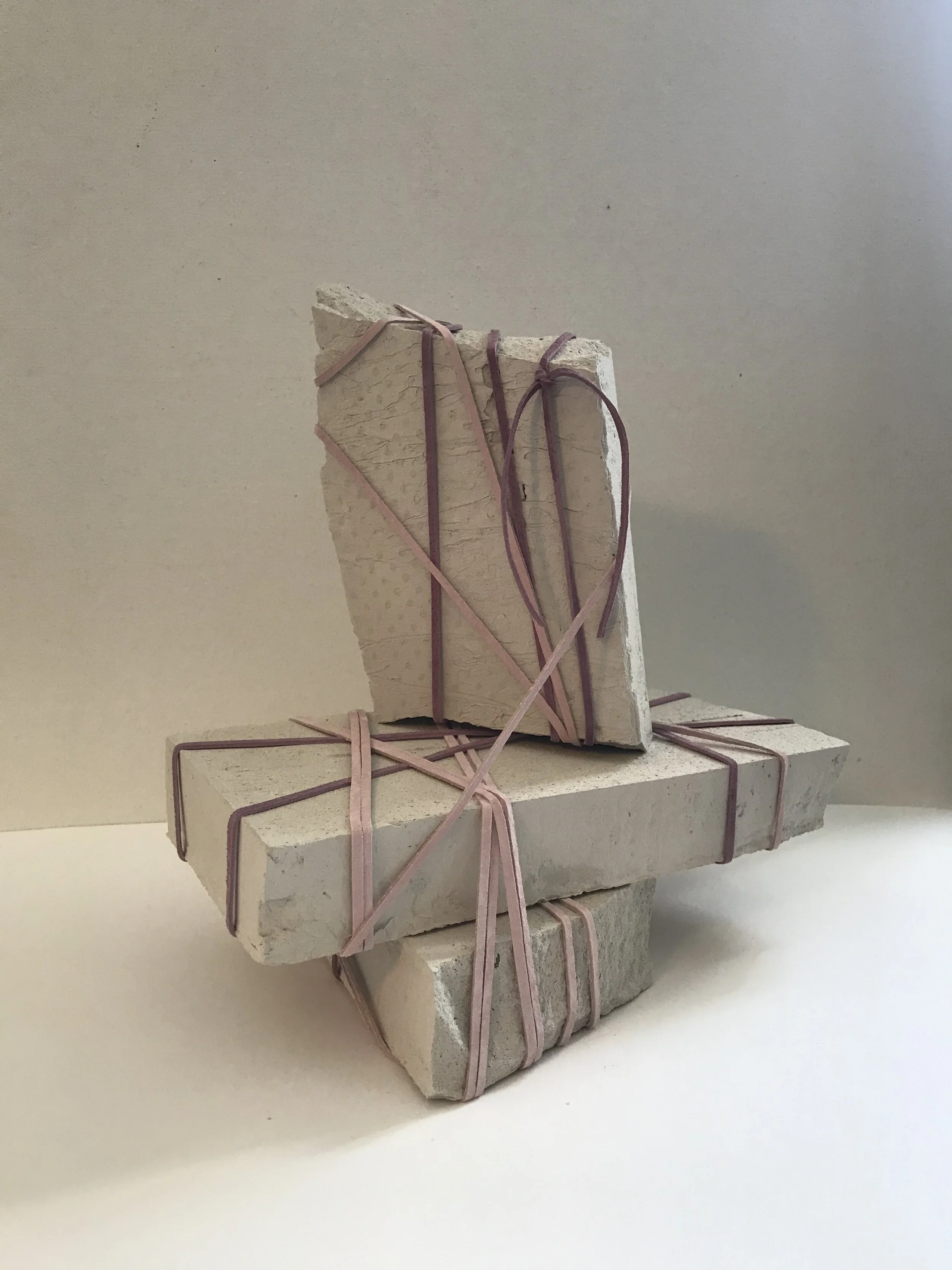 (w)Rapture No. 2, 2021. Assemblage of clay stone and leather laces.