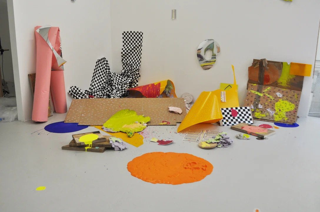Slip, 2019 Stickers, emulsion, wood, checkerboard adhesive film, cardboard, plaster, paper, vac form, acrylic 243cm x 515cm x 424cm