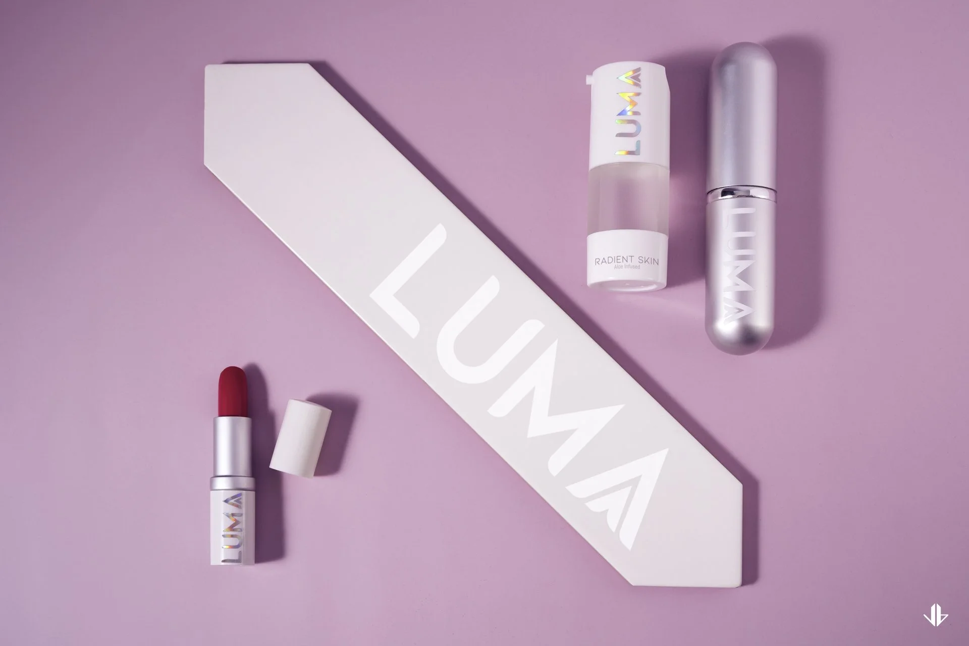 Cosmetics packaging design for a lipstick and serum line, with a sleek modern geometric box