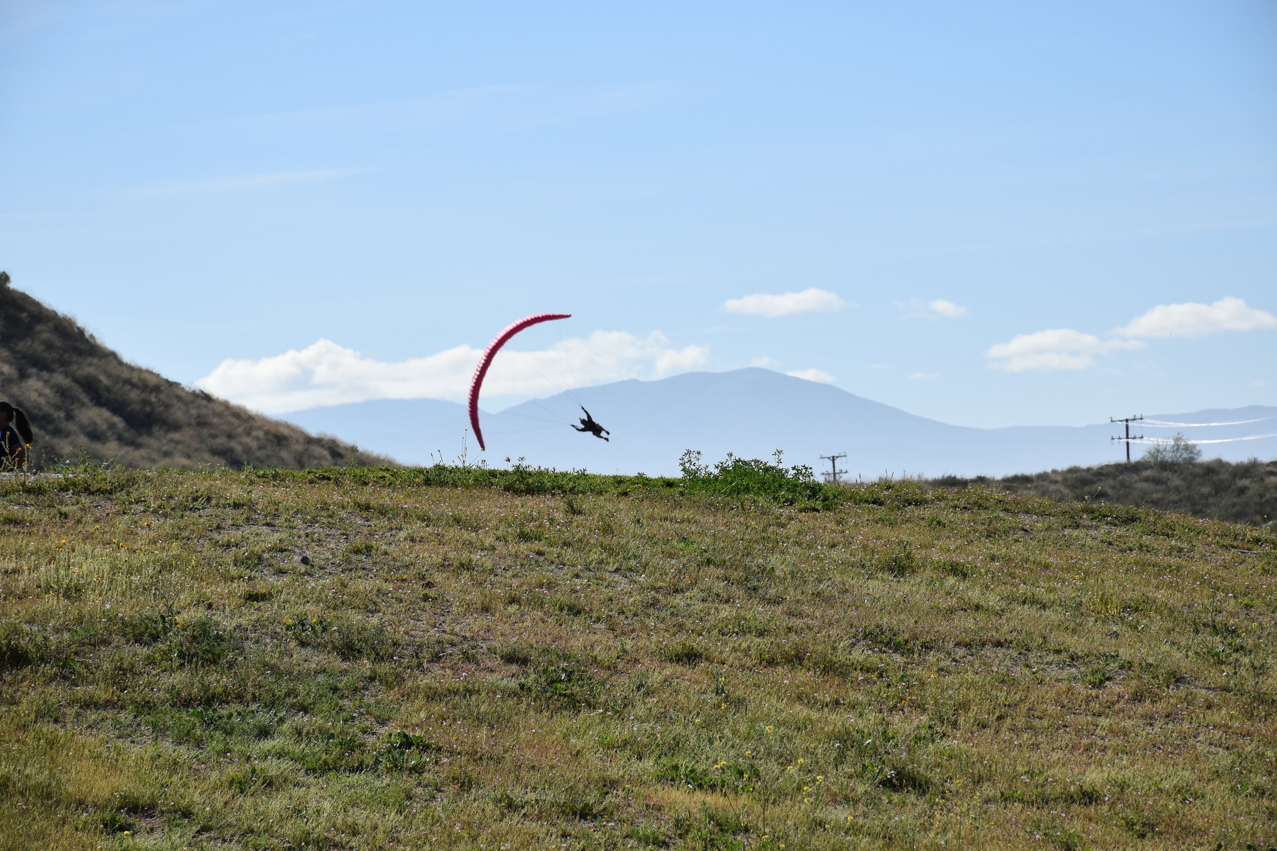 red paraglider over a field, Soboba Flight Park, learn paragliding and paramotoring at our camp