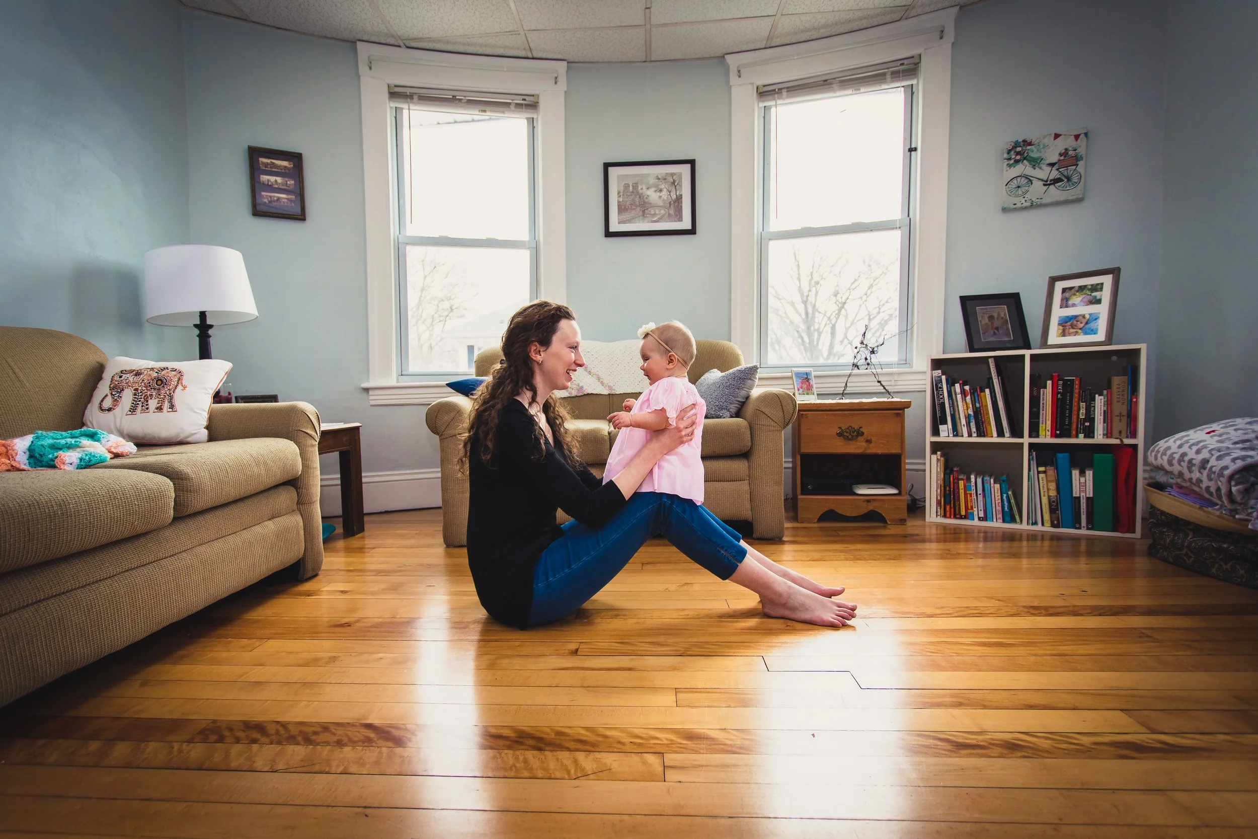 Candid family lifestyle portrait of mom and daughter sitting on the floor by Worcester photographer Tom Godfrey Photography.