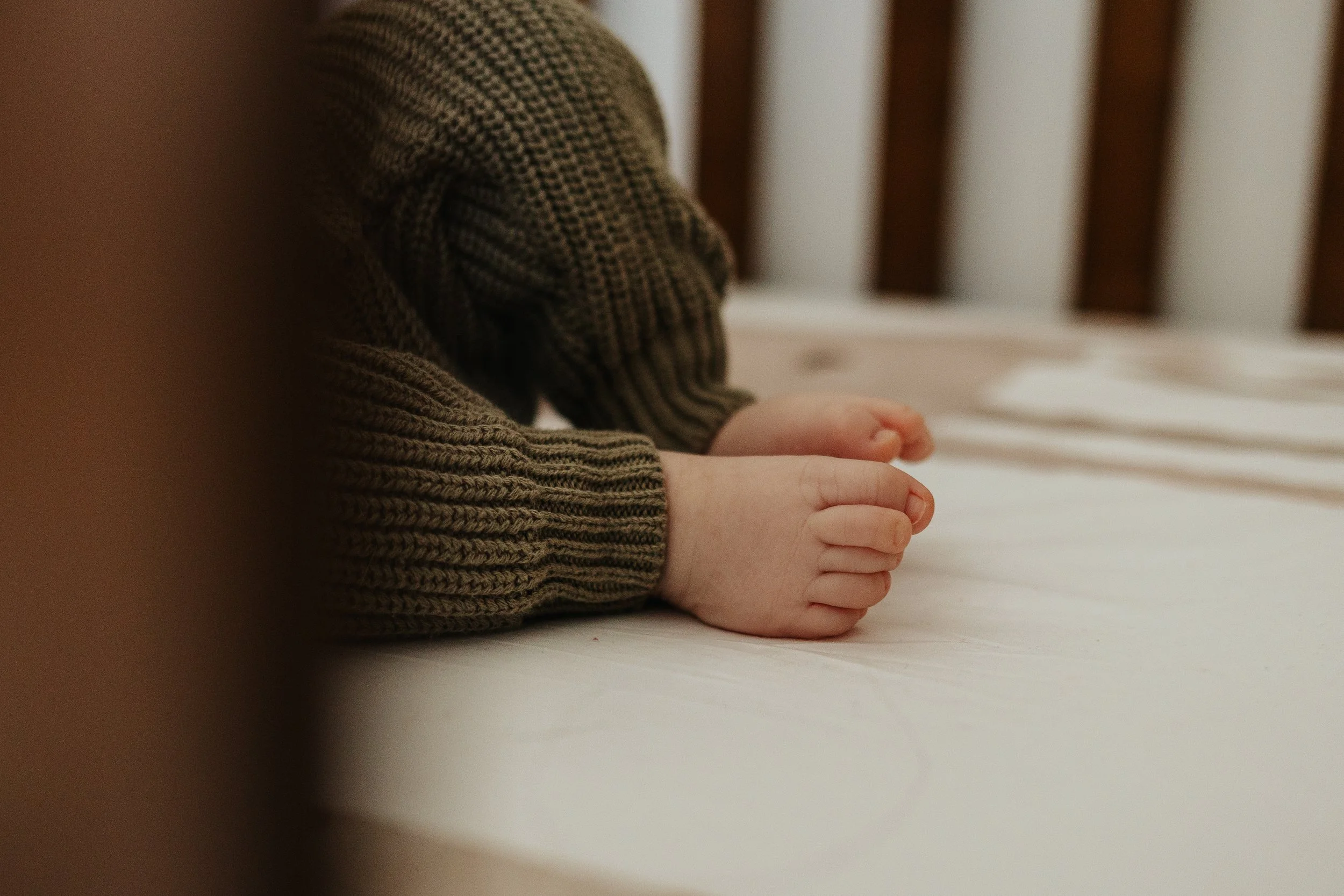 Detail photo of newborn feet during a lifestyle family portrait session in Lancaster MA.
