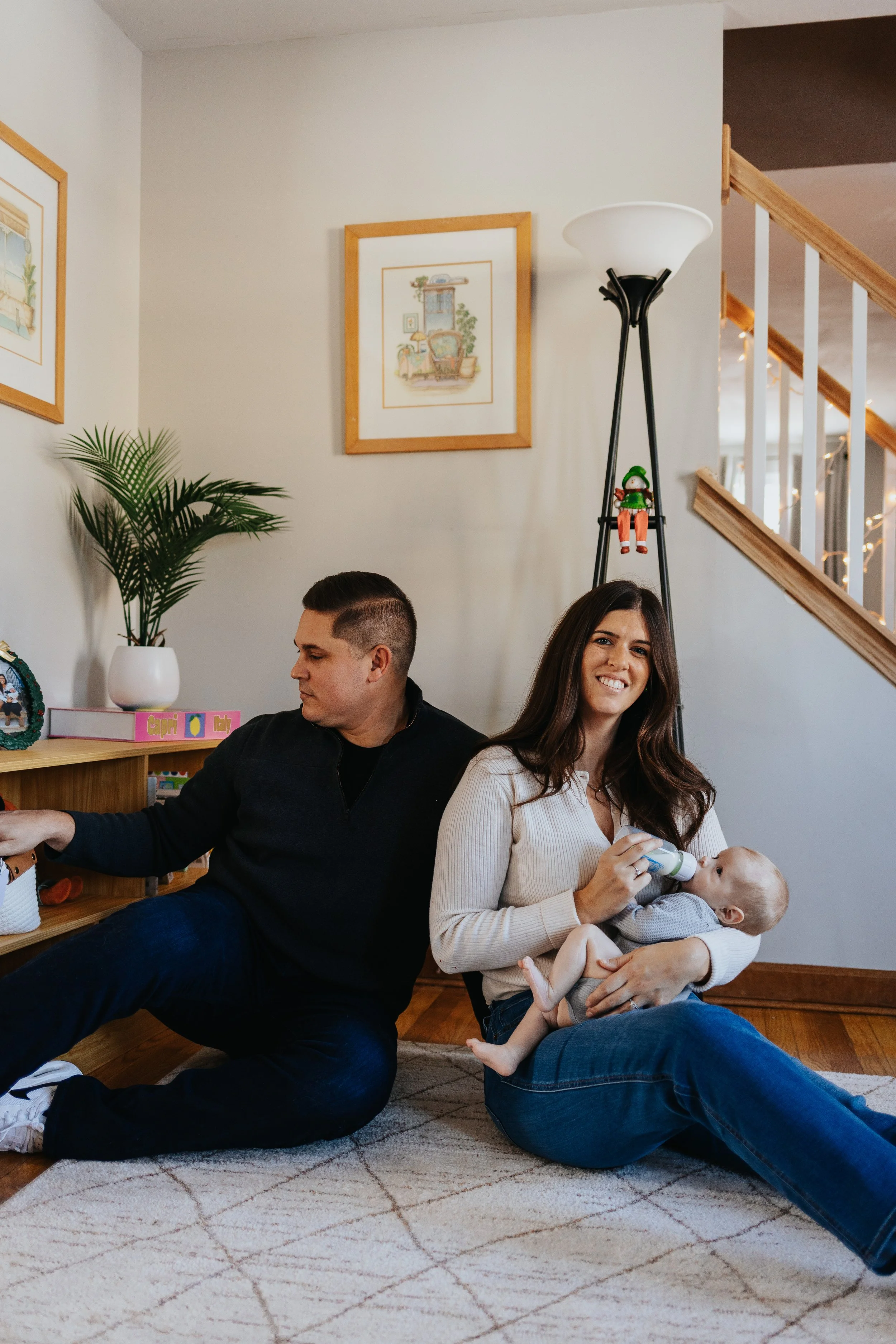 Family playing on the floor during a lifestyle family portrait session in Lancaster MA.