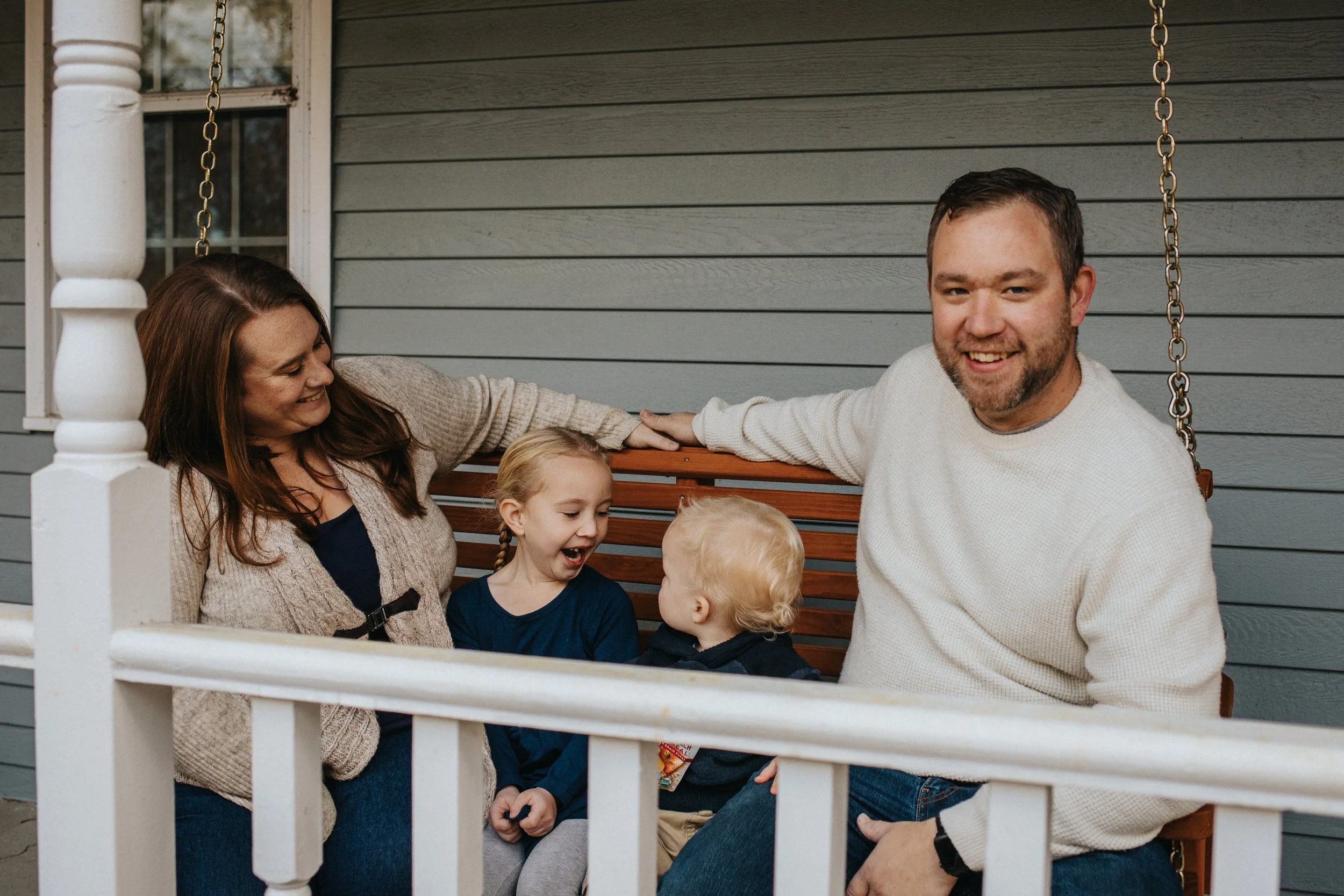 Candid lifestyle portrait of family on their porch in Holden by Worcester photographer Tom Godfrey Photography.