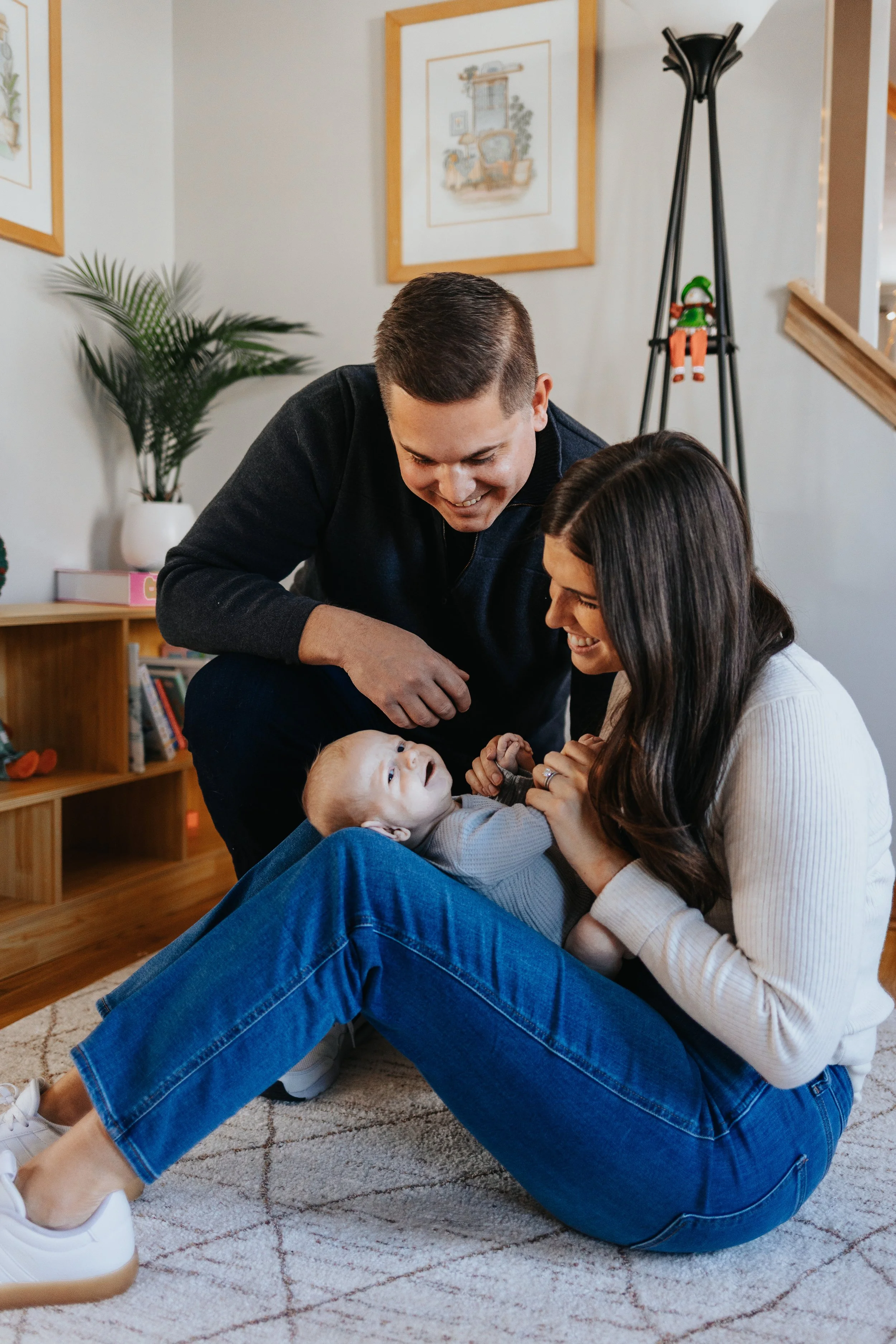 Family playing on the floor during a lifestyle family portrait session in Lancaster MA.