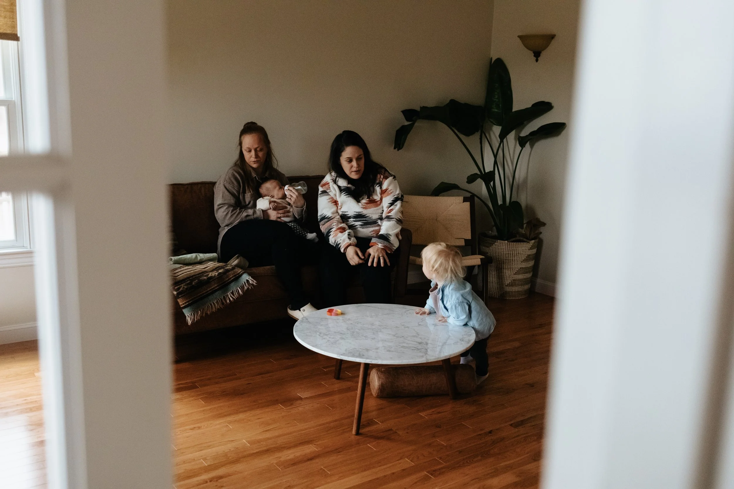 Candid lifestyle portrait of two moms and children playing at their house in Worcester by Worcester photographer Tom Godfrey Photography.
