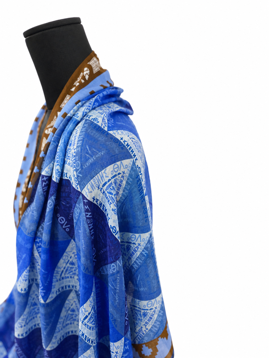 Side detail of blue Amazigh scarf by Ihsan Ishan Design showing layered geometric motifs and Tifinagh script inspired by Indigenous North African culture.