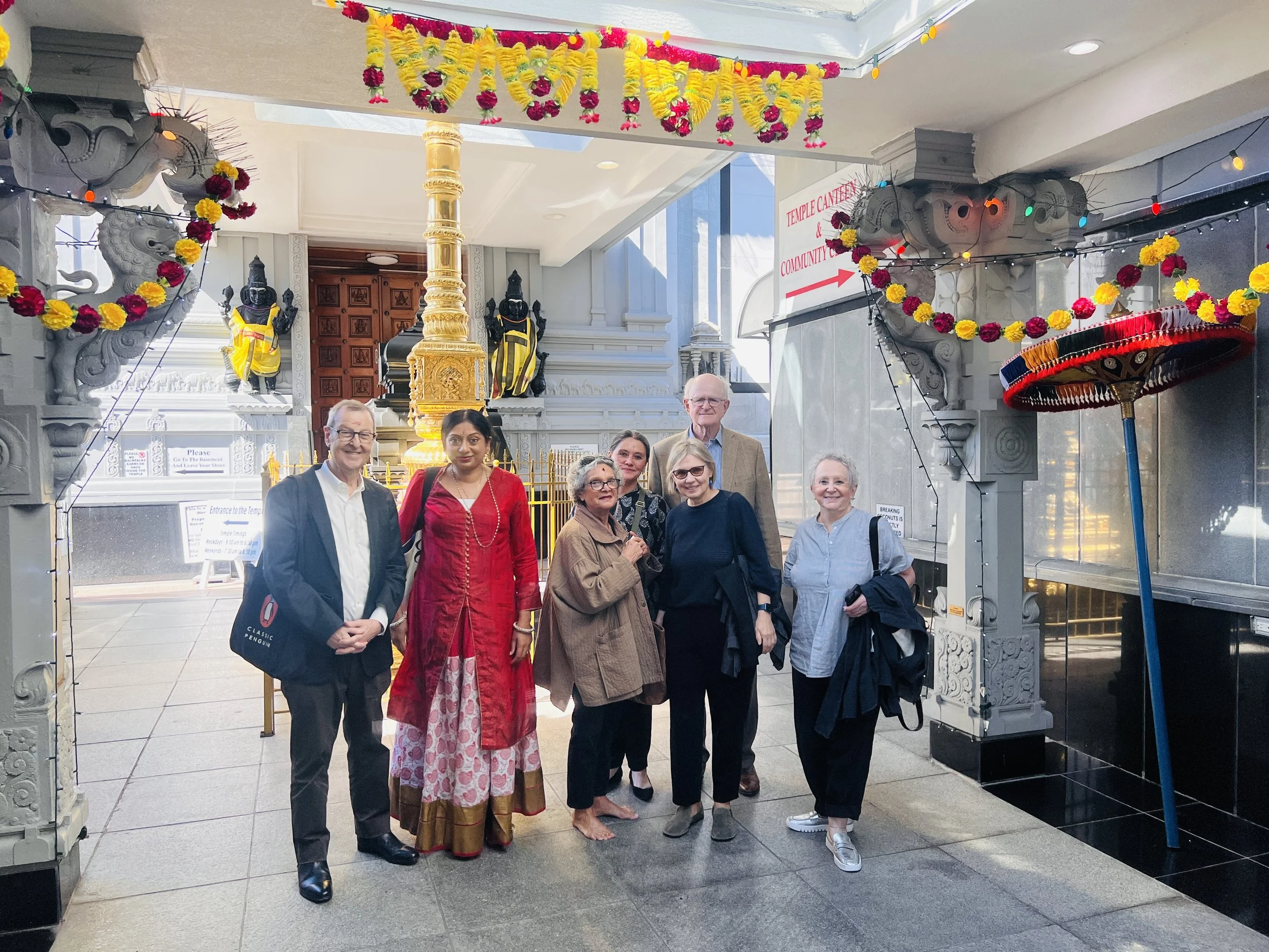 Sangeetha Kowsik with Dr. John Guy of The Metropolitan Museum of Art and museum colleagues during a visit to the Hindu Temple Society of North America in Flushing, New York.