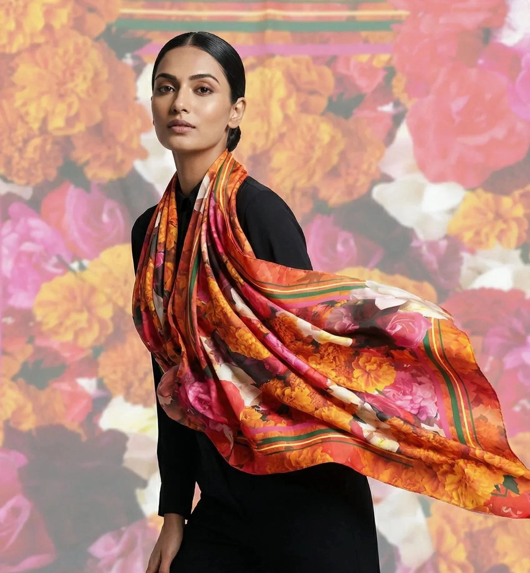 Model wearing the Marigold and Rose silk scarf designed by Sangeetha Kowsik, featuring vibrant floral artwork inspired by meaningful symbolism and design research.