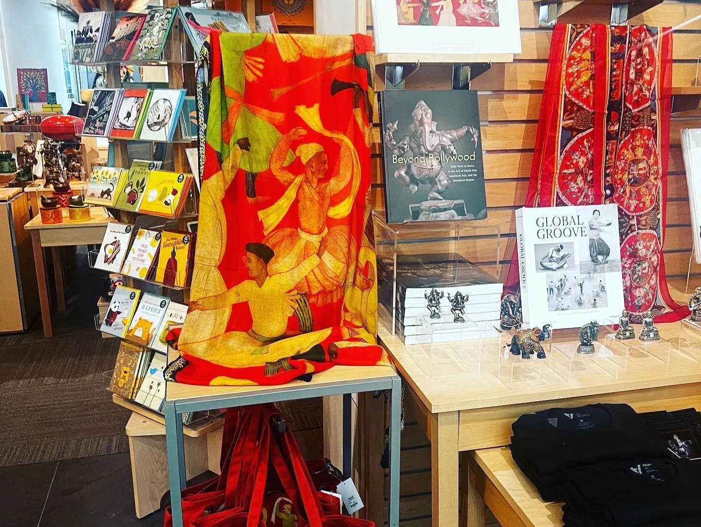 Beyond Bollywood scarf designed by Sangeetha Kowsik displayed in the Asian Art Museum shop alongside merchandise for the exhibition on Indians in America.