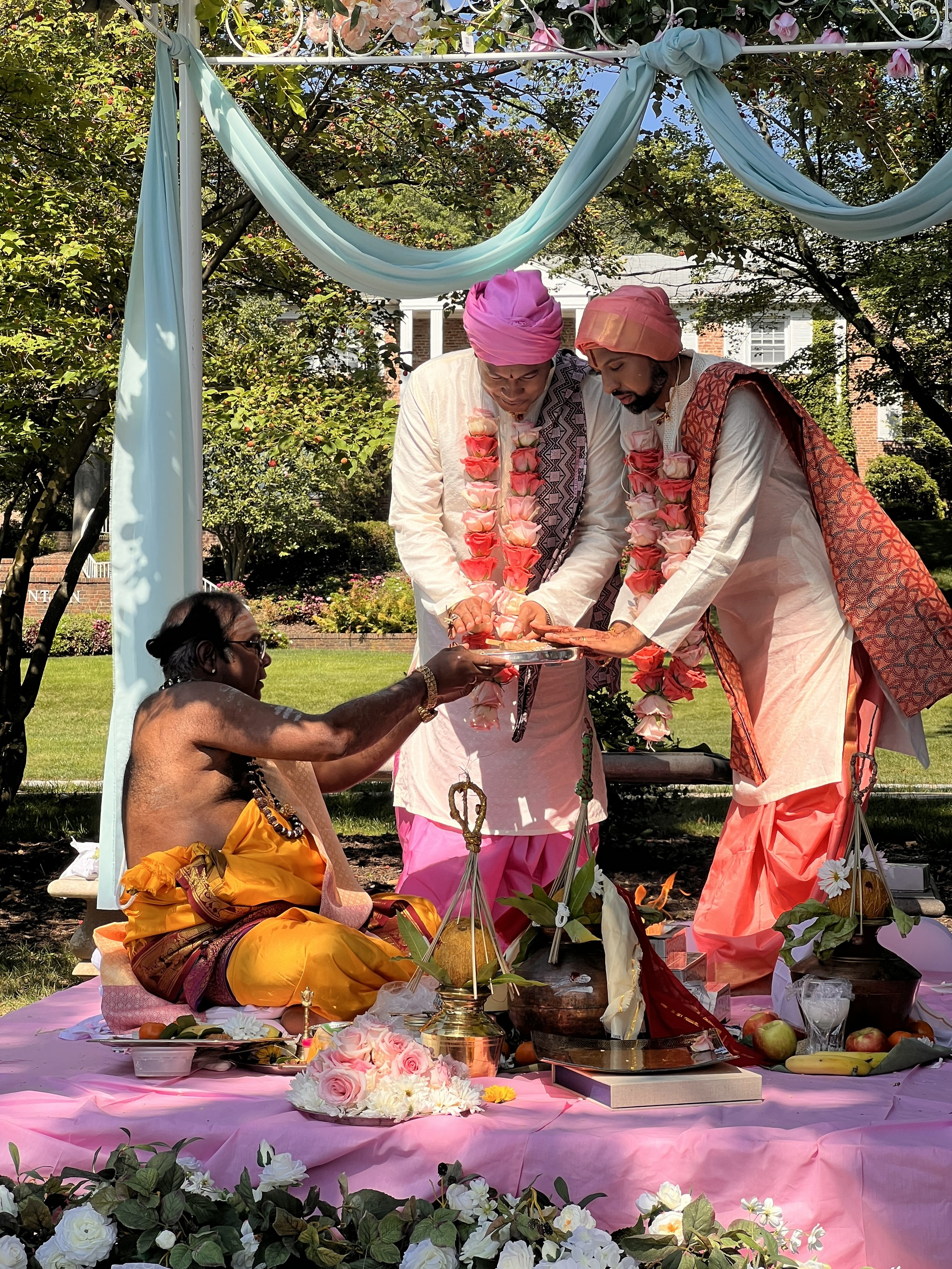 Yoruba and Hindu interfaith wedding designed by Ihsan Ishan Design, featuring a custom monogram and ceremony incorporating traditions honoring Saraswati and Oba.