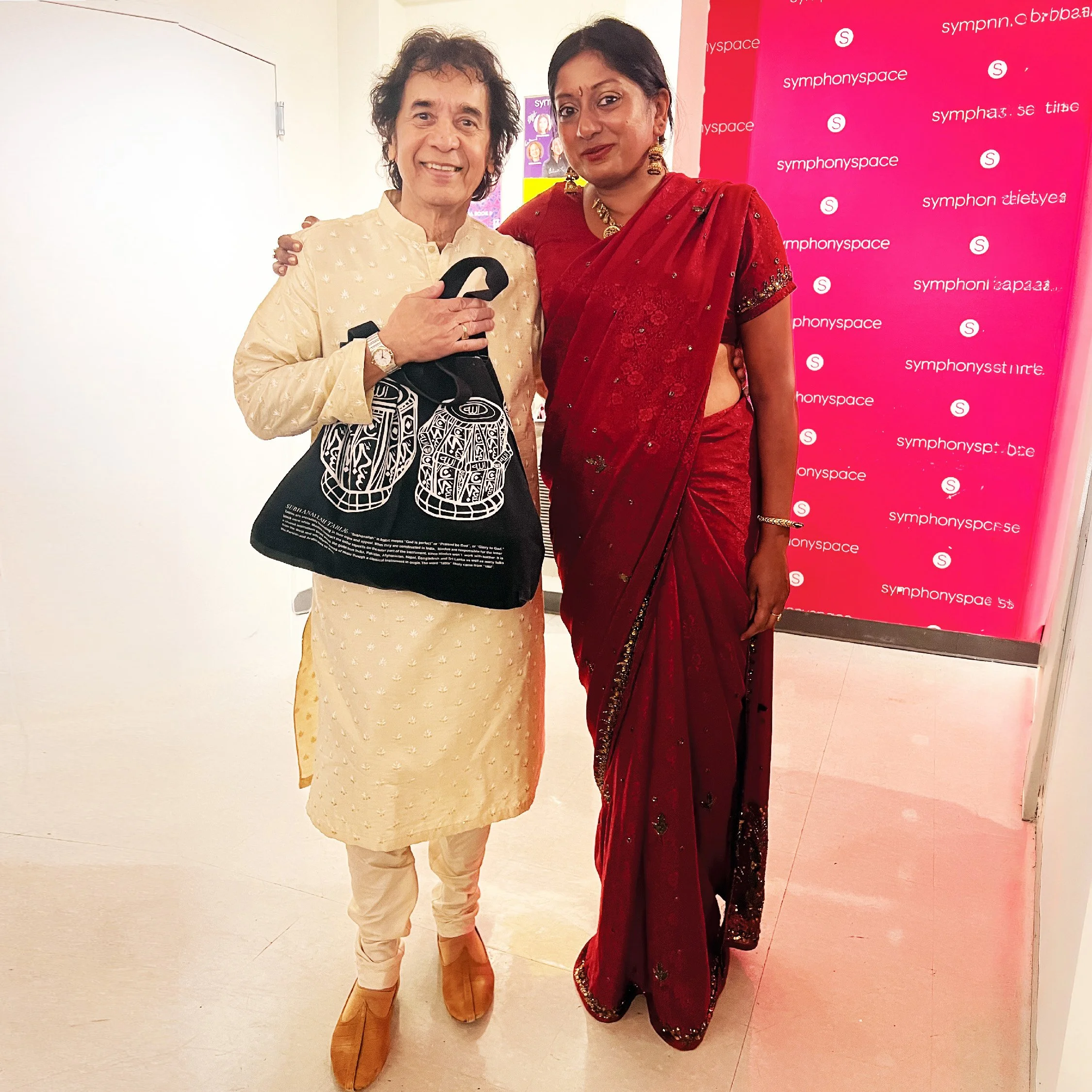Tabla maestro Zakir Hussain with designer Sangeetha Kowsik holding her Subhanallah Arabic Calligraphy Tabla Bag at Symphony Space in New York City.