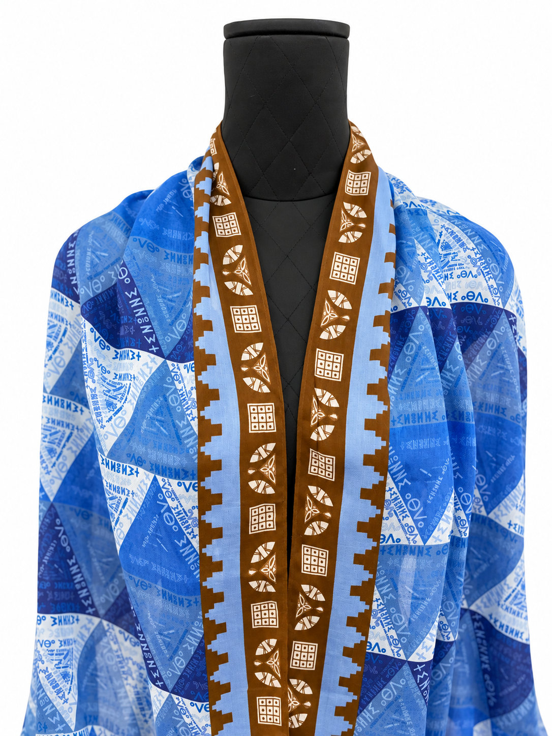 Detail of blue Amazigh Tillei Abda scarf by Ihsan Ishan Design featuring Tifinagh script, geometric patterns and motifs inspired by Indigenous North African design.