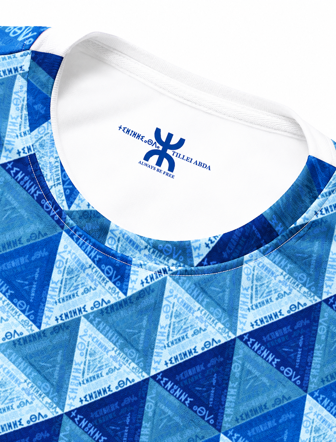 Close-up of the blue TILLEI ABDA Amazigh sweatshirt showing the geometric pattern, crew neckline and Ihsan Ishan Design label.