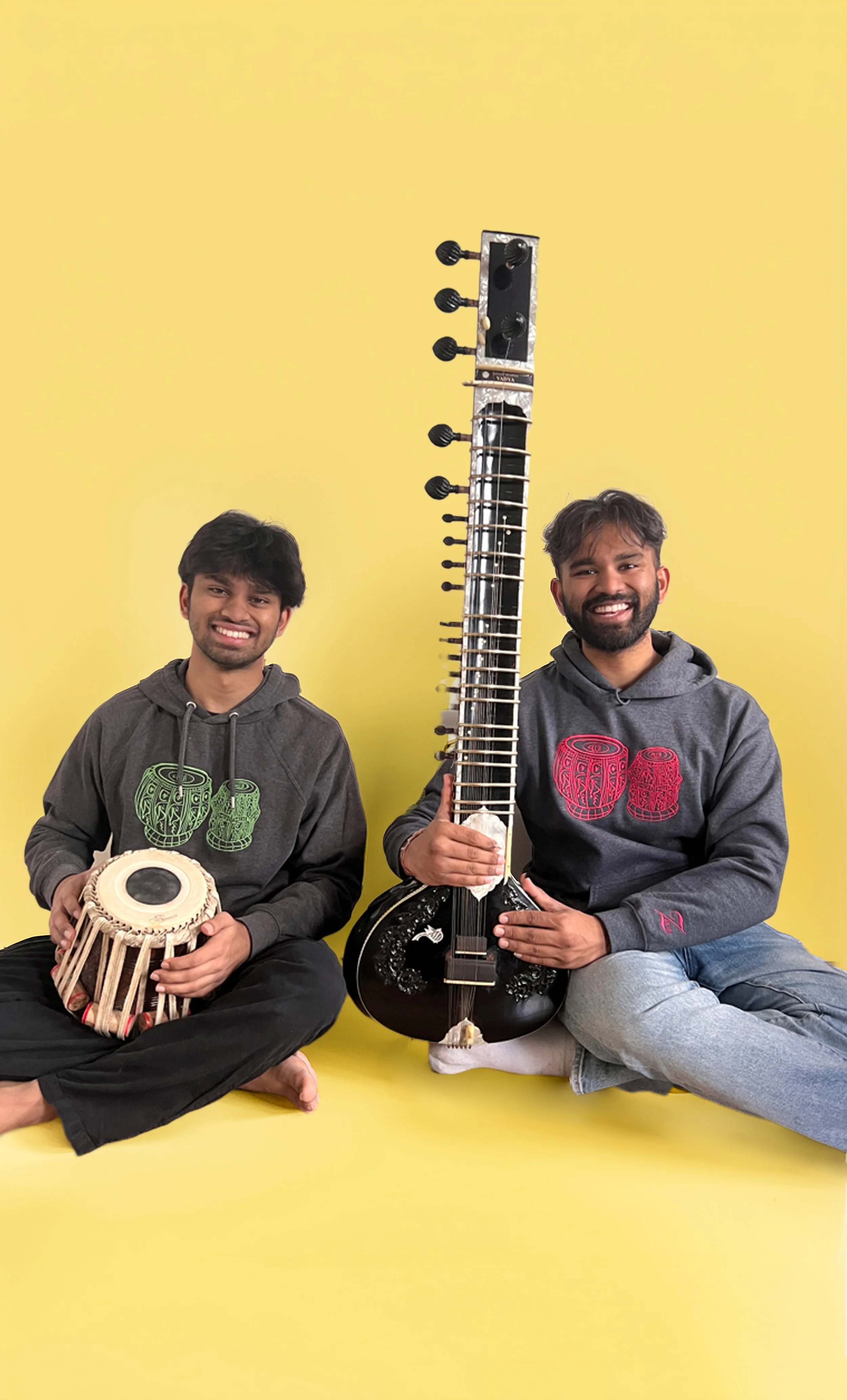 Indian classical musicians wearing Subhanallah Tabla sweatshirts by Ihsan Ishan Design, photographed with tabla and sitar.