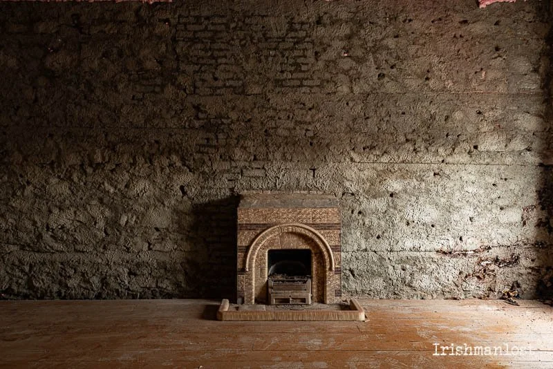 Ornate fireplace, wall has been treated for dry rot