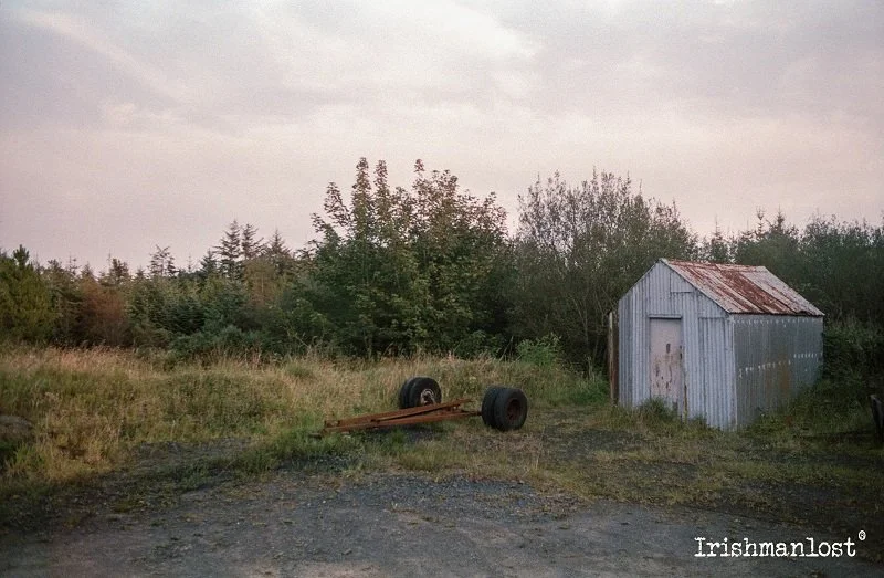  Jessops 200 Expired - Nikon FM + 50mm The humble tin shed, once essential in rural Ireland, now stands as a weathered relic. Used for farming, workshops, and small industries, these structures symbolized resilience and hard work. Over time, economic