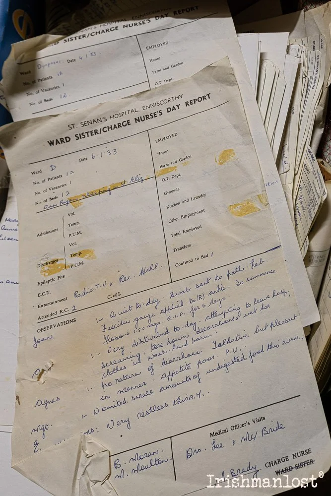 A hospital nurse's day report form from St. Senan's Hospital in Enniscorthy, dated June 1, 1983, with handwritten notes and a stack of similar documents.