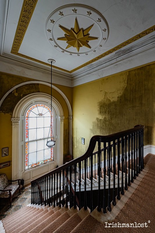 Stairway To The Stars - starcase inside a beautiful abandoned home with a star pattern ceiling rose