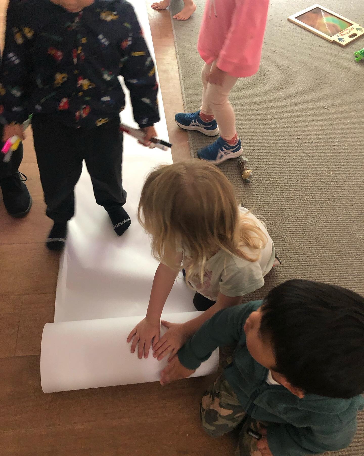 ELC children developing their pencil grip and fine motor skills. We helped set up the experience as we rolled out the paper and then taped it down at the corners. It was lots of fun drawing and scribbling on the paper.