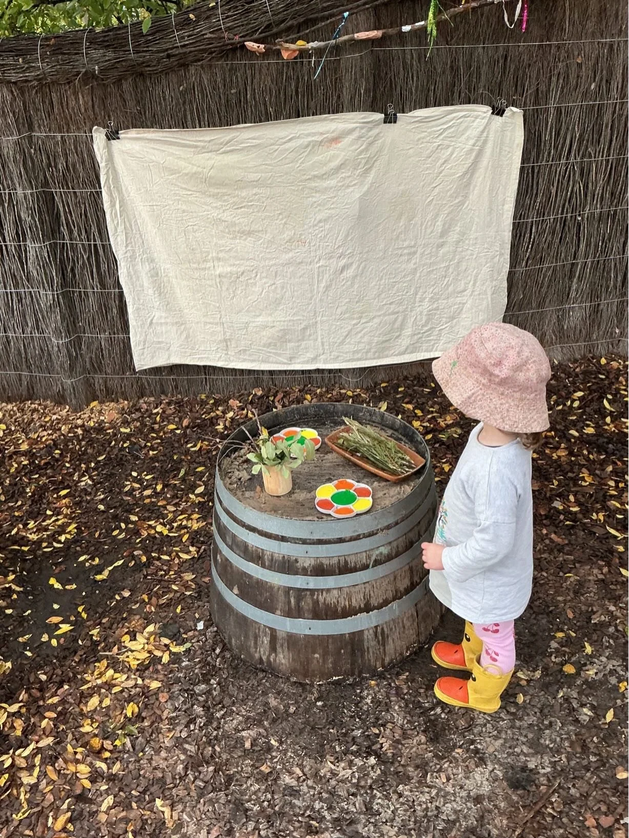The preschool children worked together to create a collaborative outdoor canvas using sticks, leaves, and other natural materials to blob, splat, smear, and spread paint in their own unique ways.

As they painted, the children hypothesised, experimen