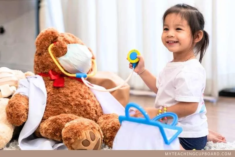 Child in dramatic play caring for toy animals