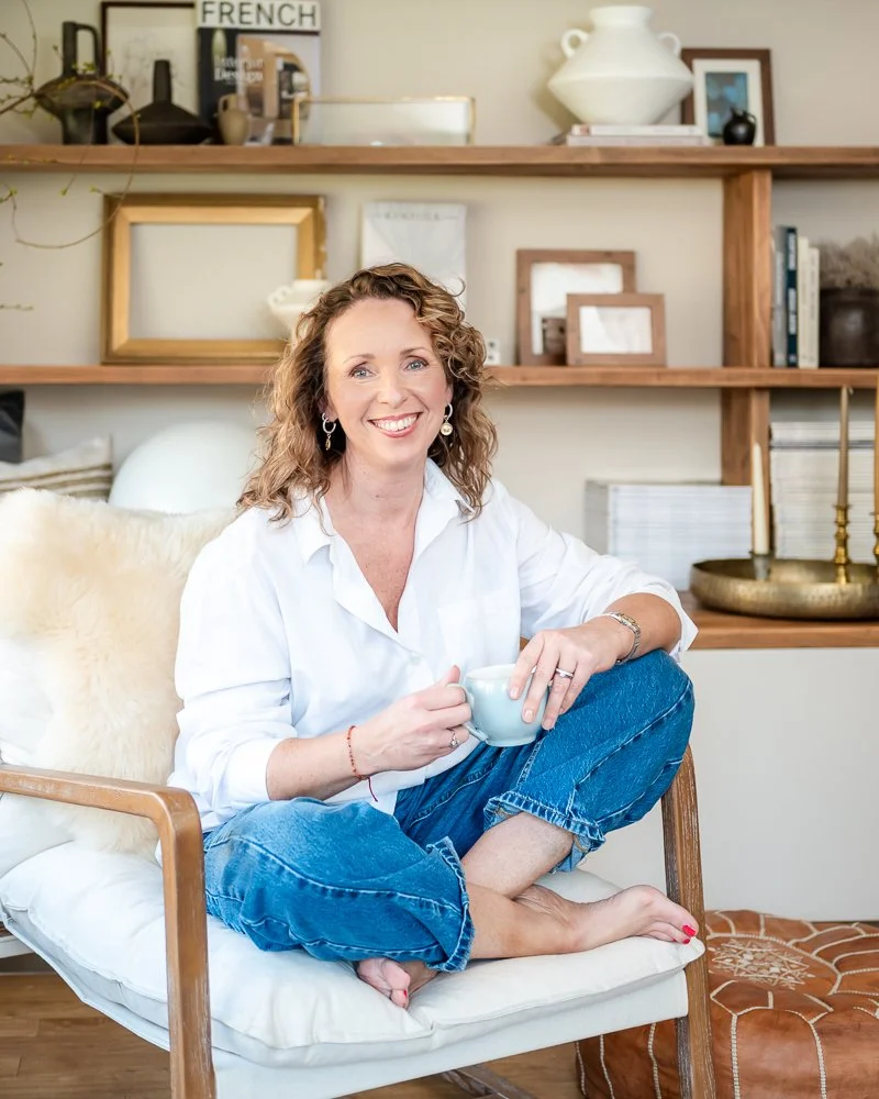 interior designer sat in a chair having a cup of tea during a brand photography shoot in Lancashire