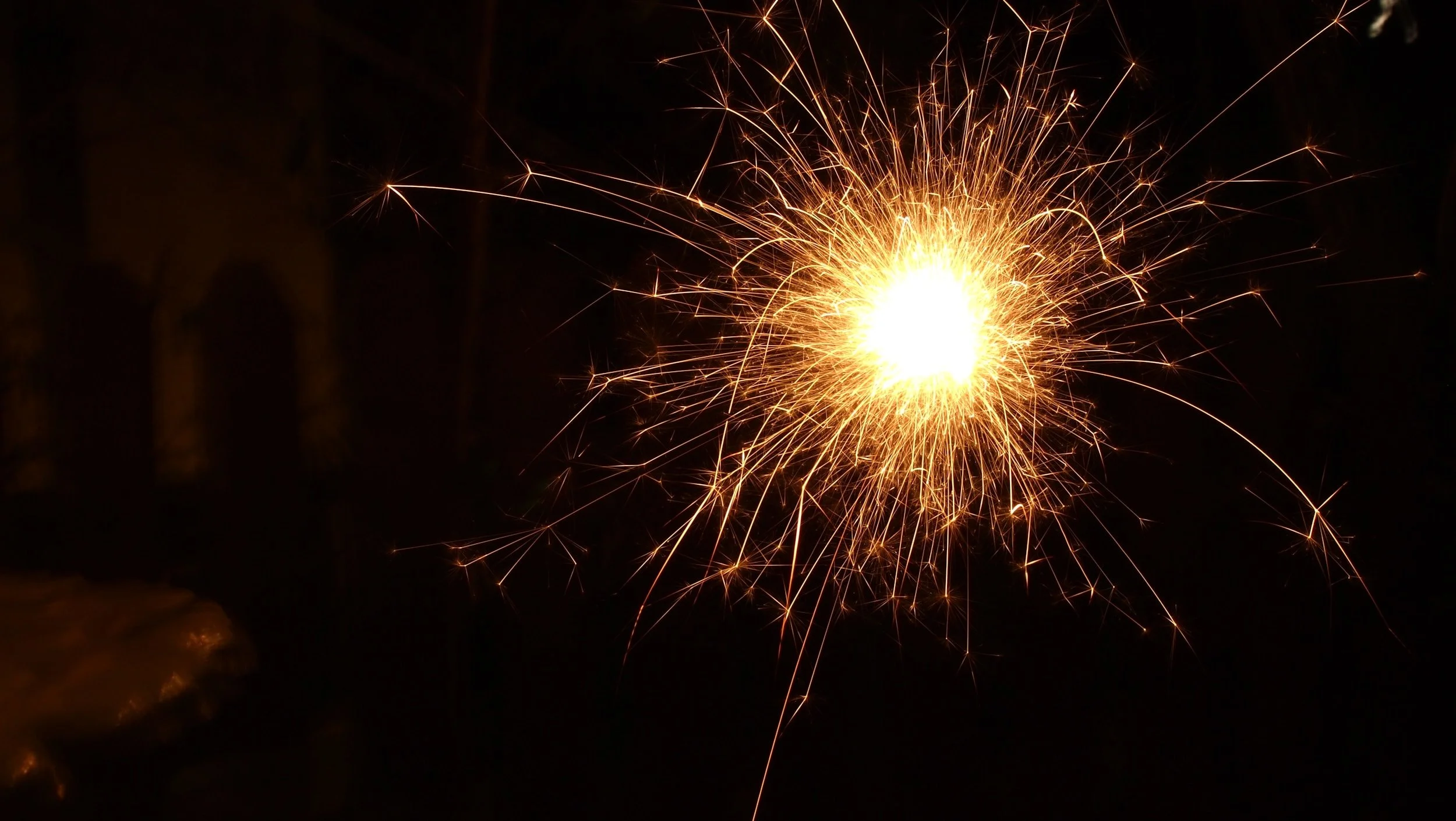 Close-up of a spark igniting in the dark.