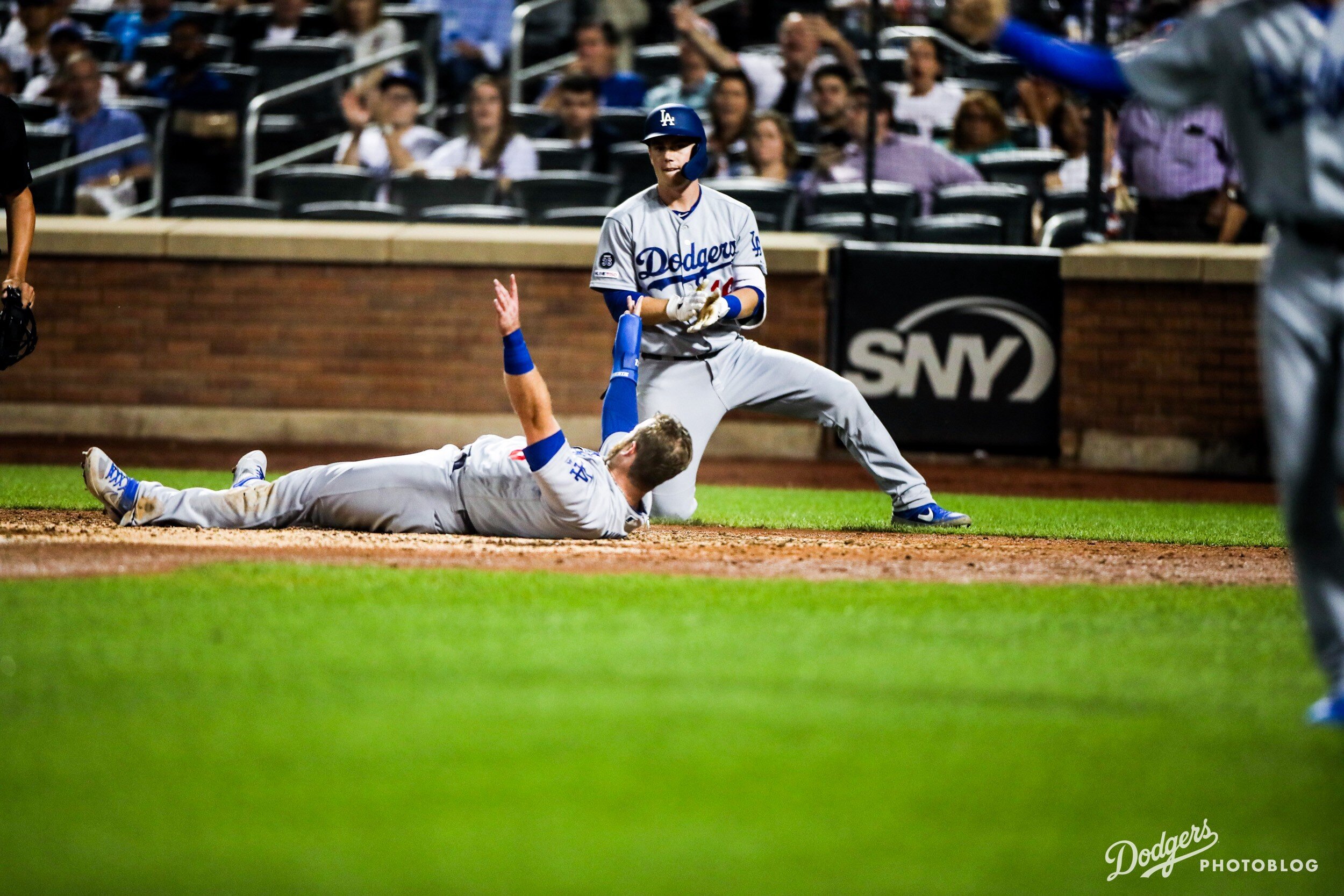 Max Muncy laying on the ground after scoring a run. Lucas Stevenson/MLB.com