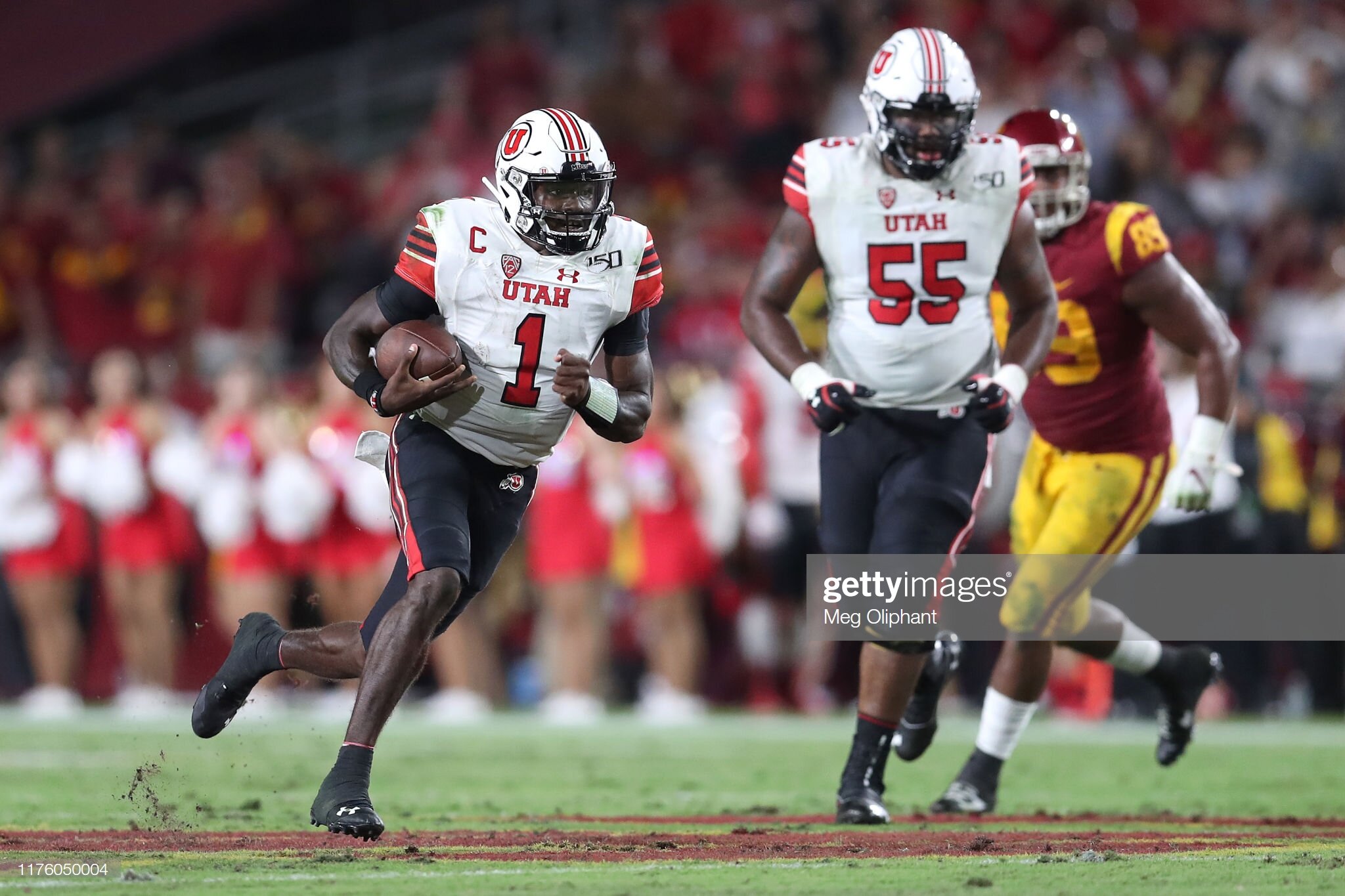 Utah quarterback Tyler Huntley evading pressure.