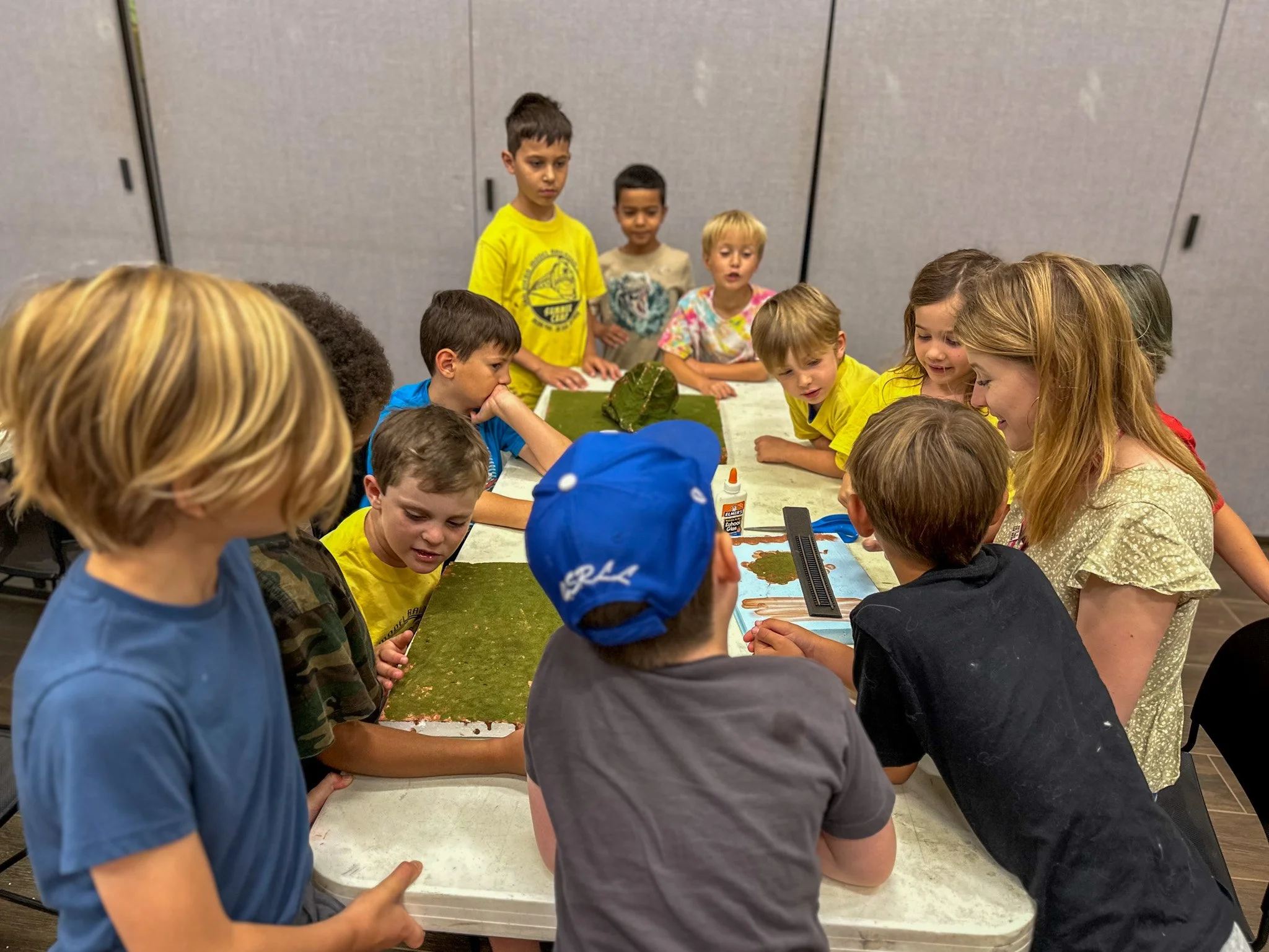 San Diego Model Railroad Summer Camp. Group of kids building a model layout at summer camp