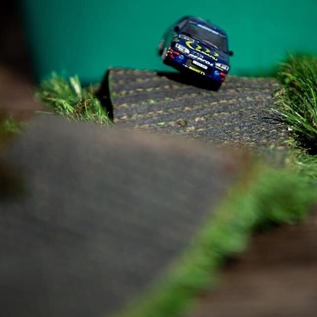 Bored, so tried a diorama and then a composite. McRae's 1995 Subaru 555 1/43 model. I used some off cut from my artificial grass and balanced the model on a piece of rubber , to give it the effect of it coming over the hill and then added a photo I h