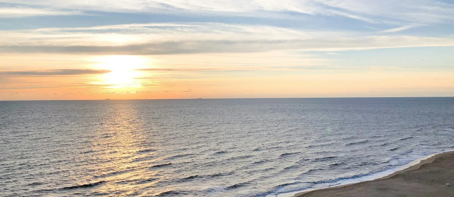 Sunlight over the ocean at dawn