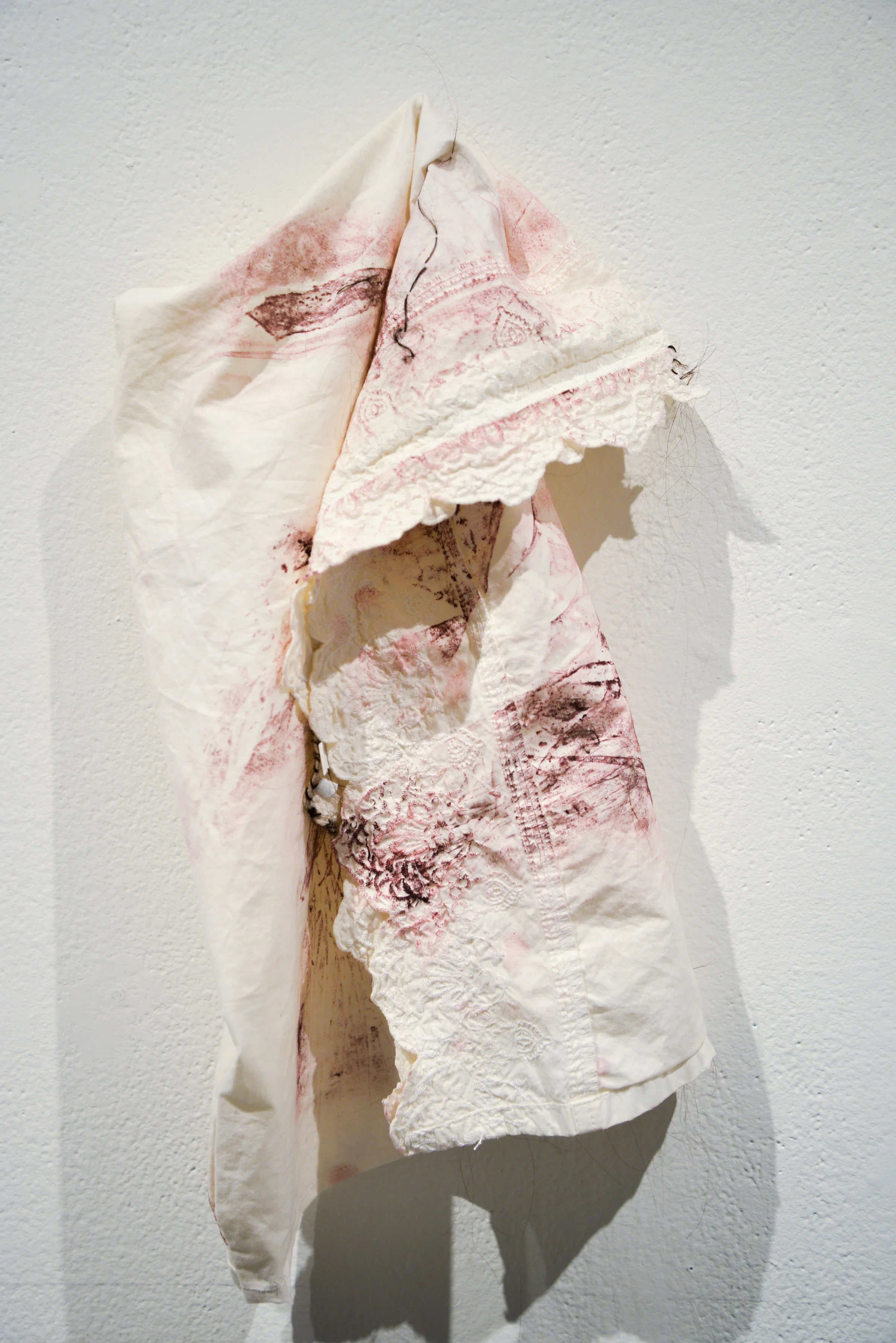 Performance Hood 3 Collograph on fabric, embroidered human hair 2017 (Photo taken by Kristina Johnson )
