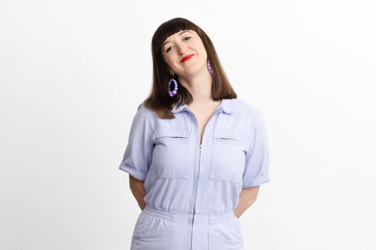 A photo of Francis van Beek smiling in a lilac boilersuit.
