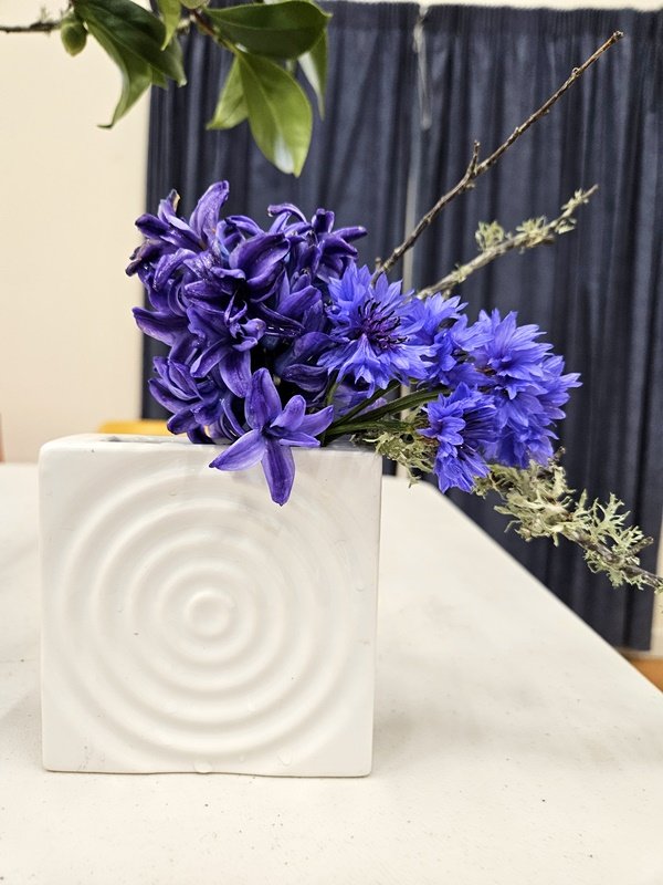 Lyn's small white vase with hyacinth, cornflowers and bare branches