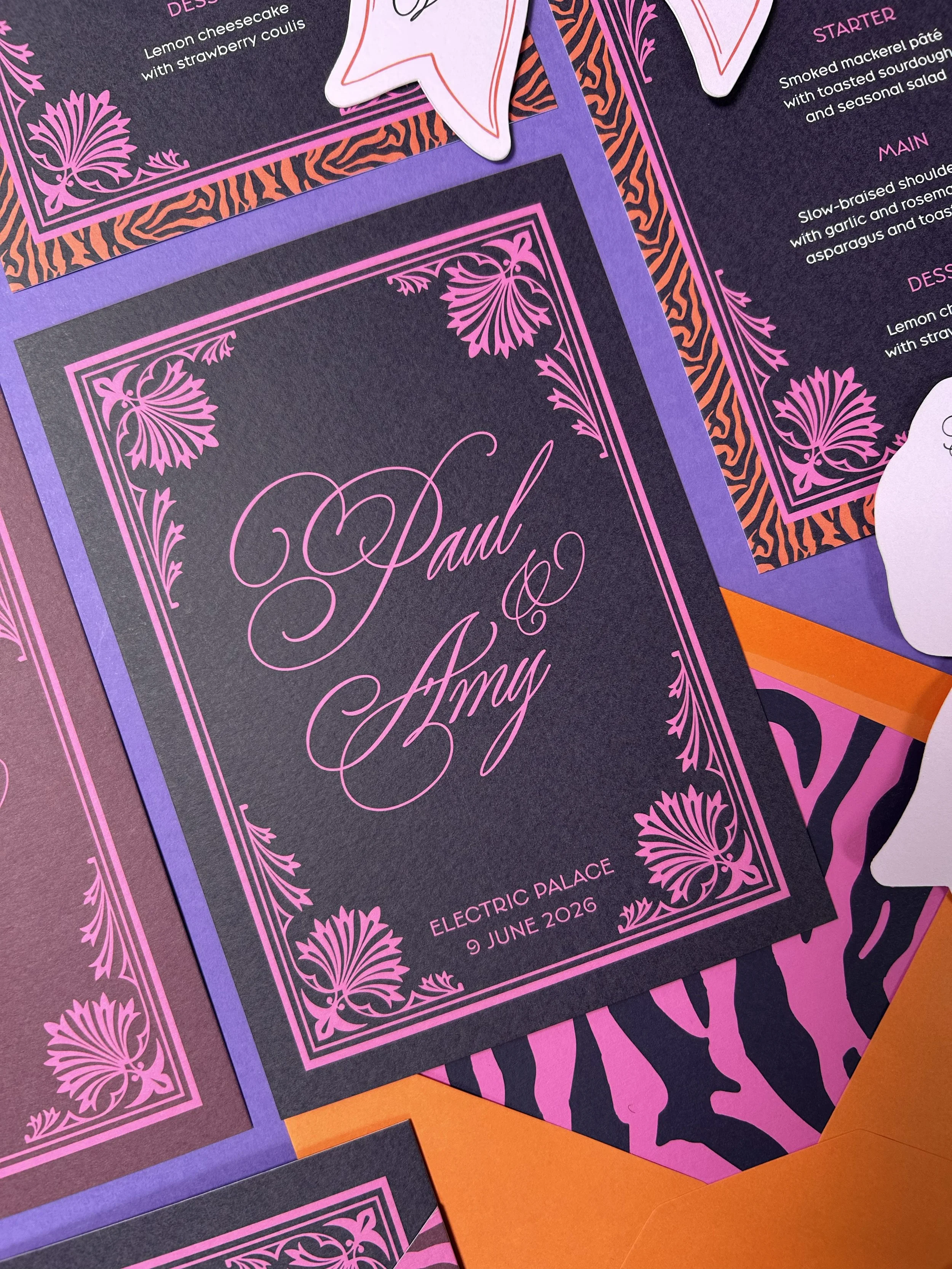 Dark and moody invitations which are paired with bright animal print envelope liners.