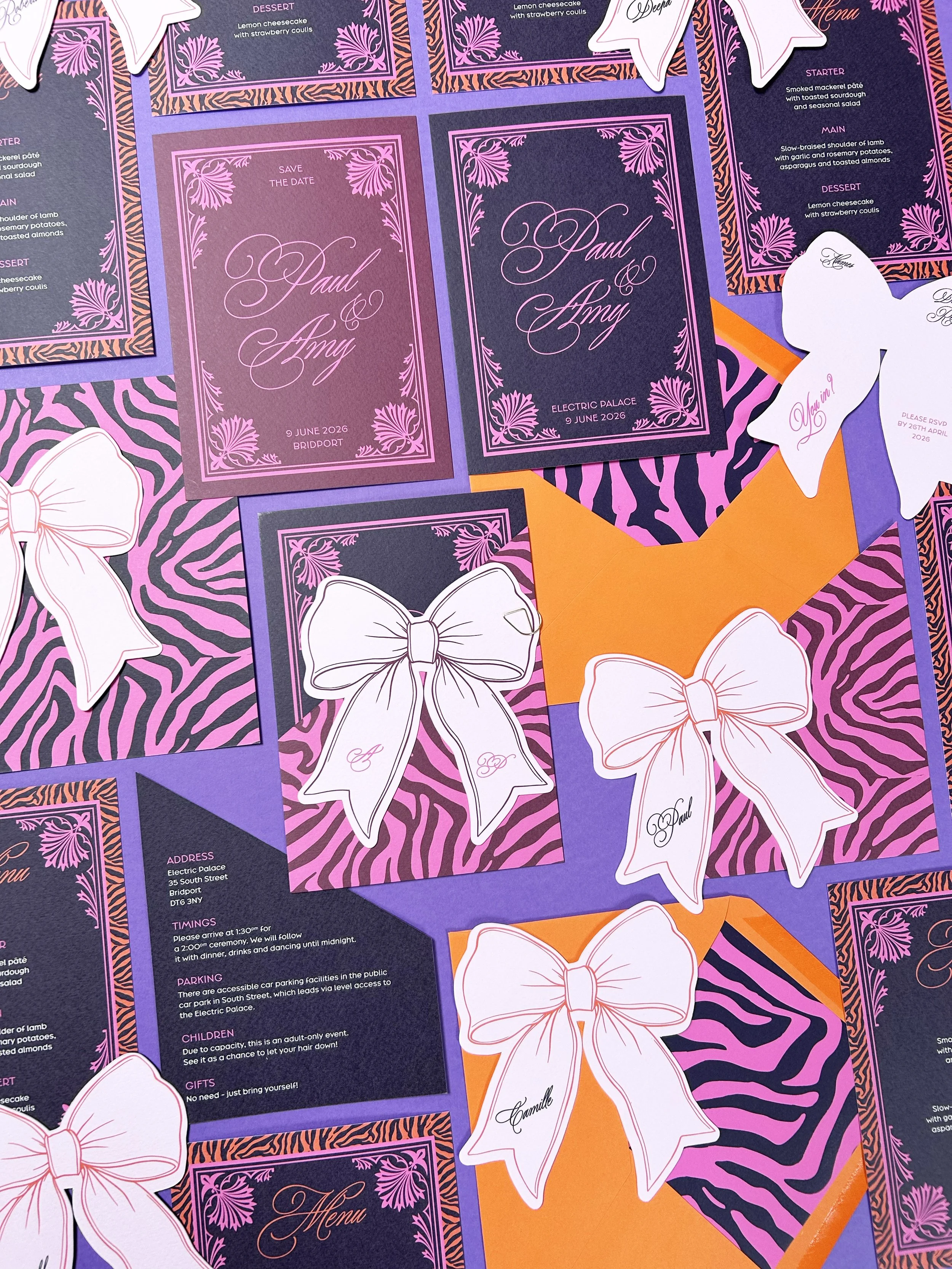 Invitation sets with save the dates, invitations, details cards, envelope liners and RSVP cards with animal print in pink and purple.