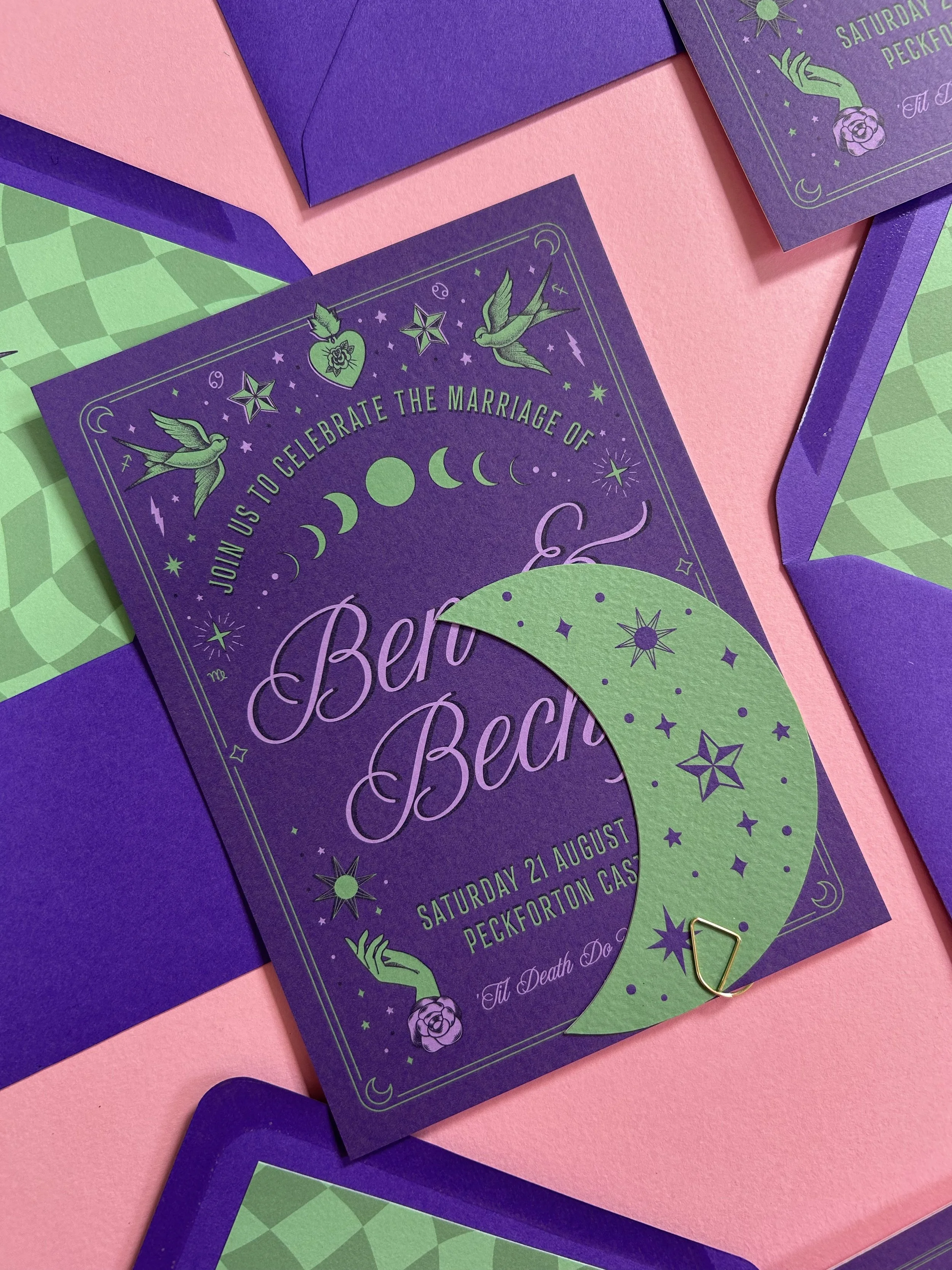 Celestial purple and green invitation packs with moon-shaped RSVP cards.